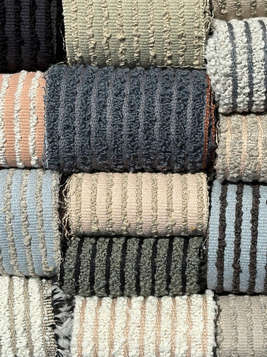 Collection of textured rugs in various colors and patterns.