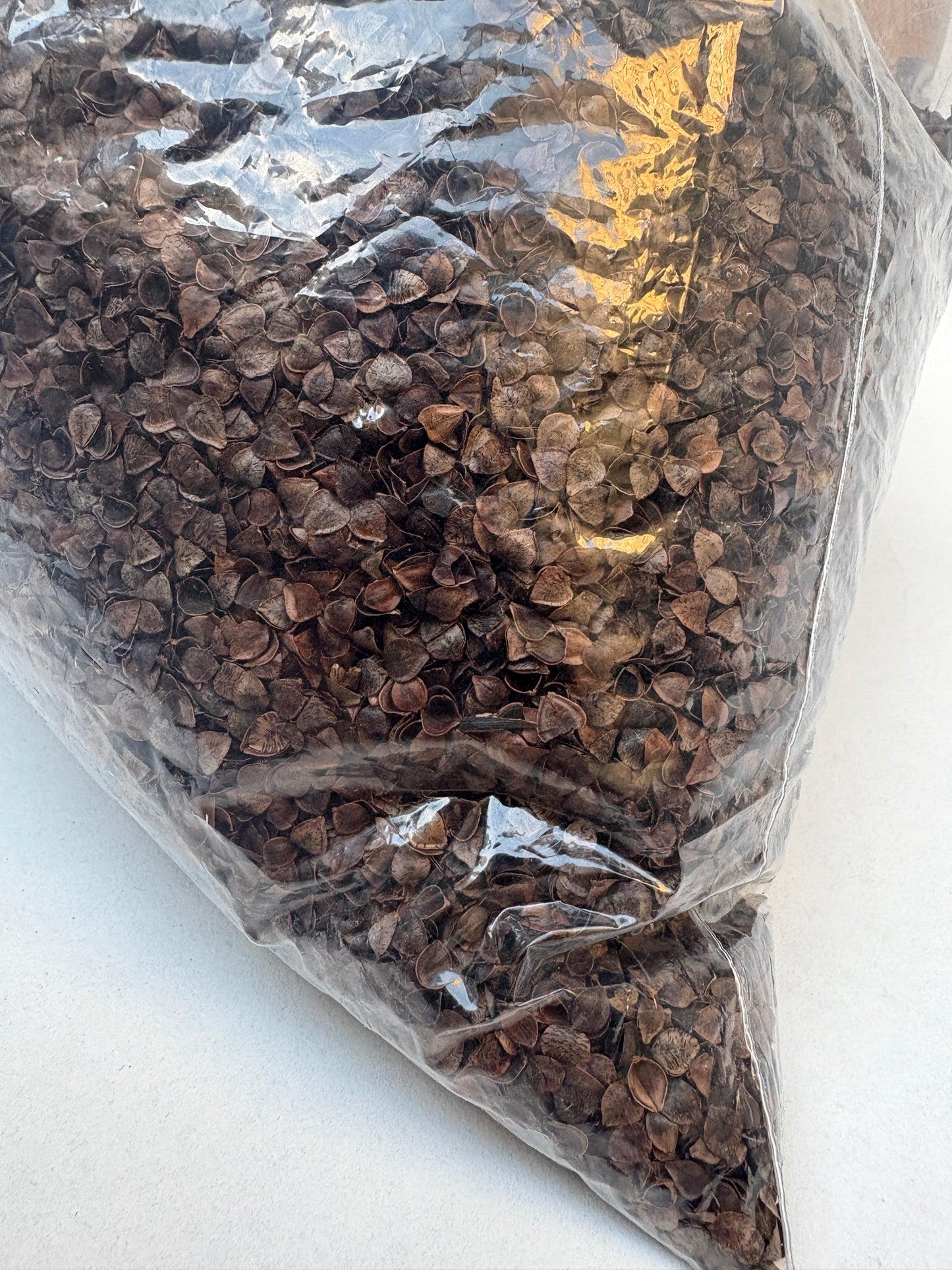 Pale fibre filling is shown inside a clear plastic bag

