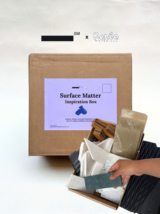 A cardboard box filled with various textured recycled plastic samples in white, gray, black, and wood-grain tones, held by a person's hand. The background a big box with purple label showcasing the packaging of the product.