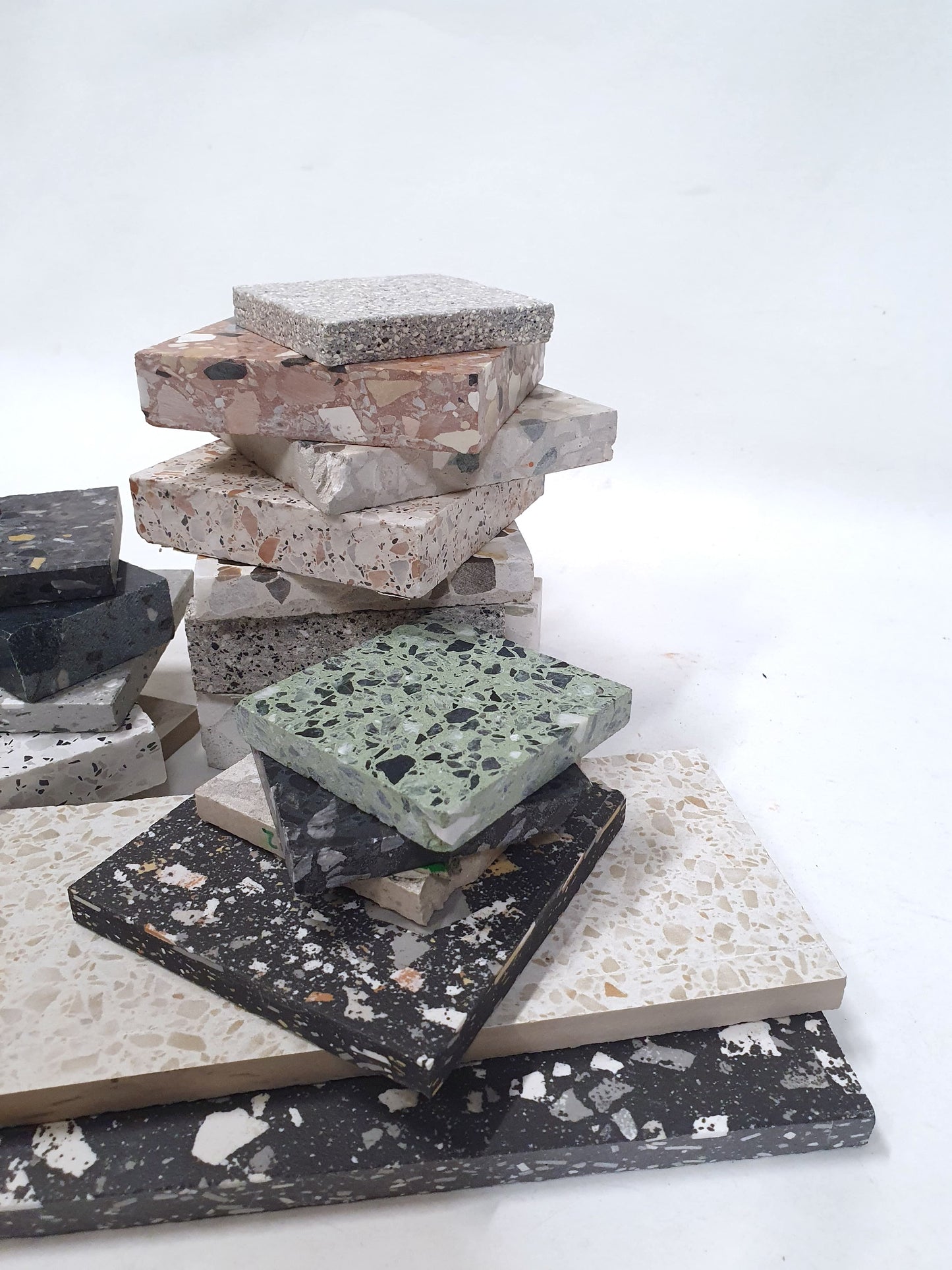 Mixed speckled sample pieces are shown in stacked and spread-out arrangements