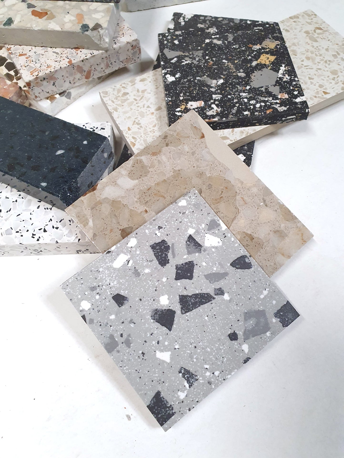 Terrazzo-effect tiles are displayed in detail from multiple angles