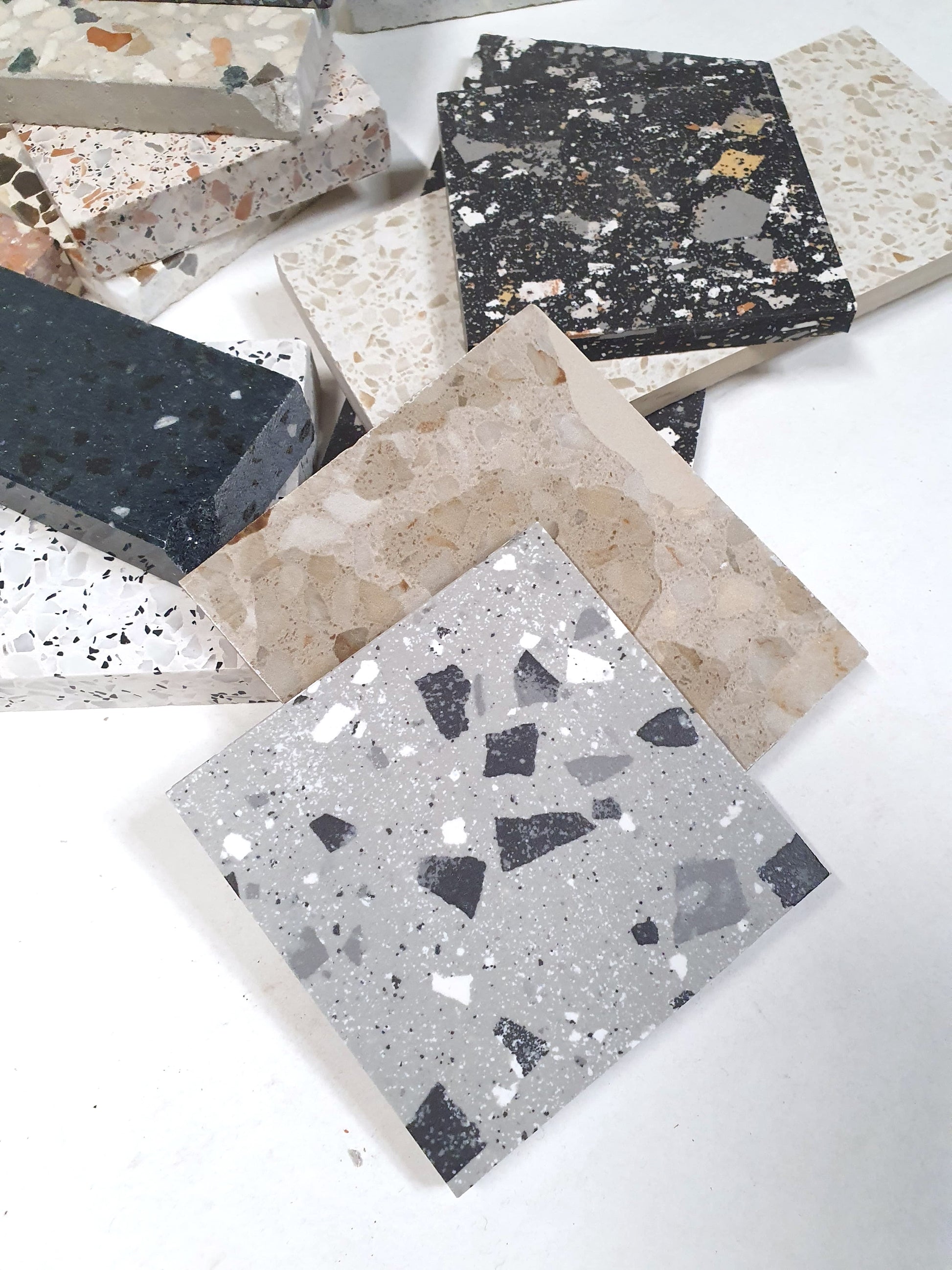 Terrazzo-effect tiles are displayed in detail from multiple angles