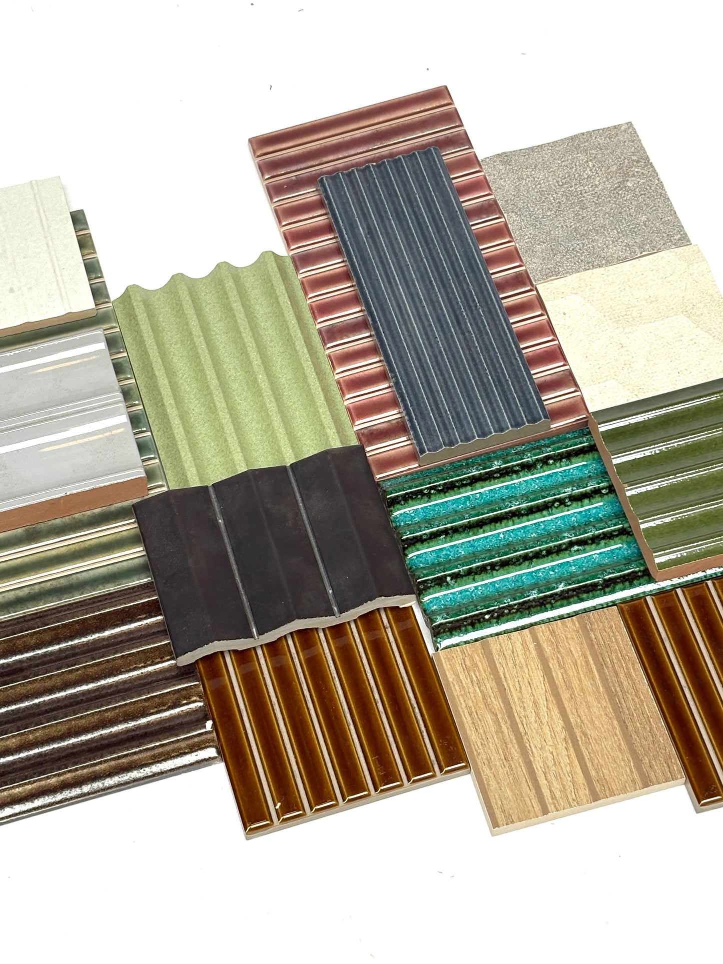Mixed bundle of textured tiles arranged on a white background.