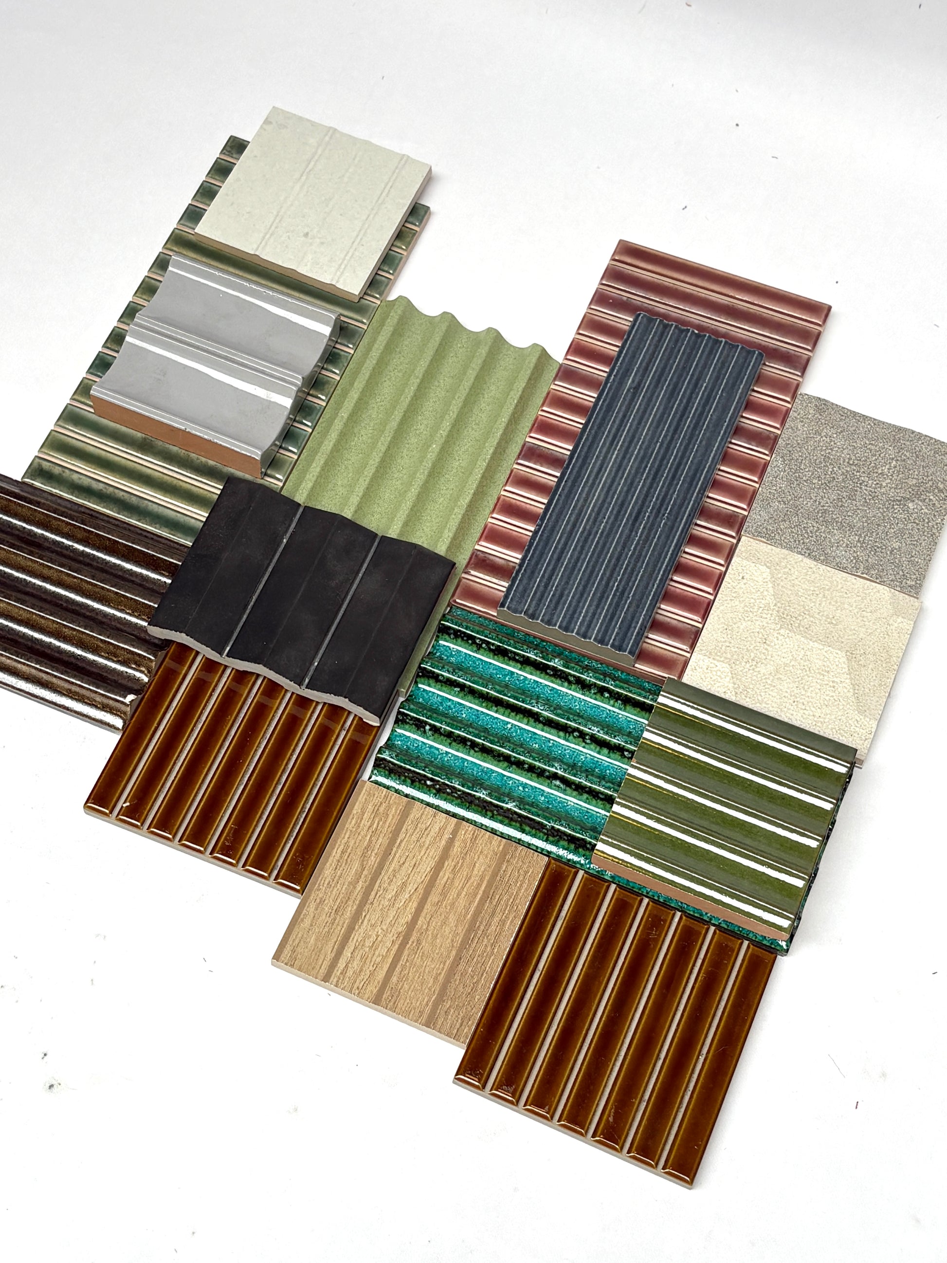 Selection of textured tiles in mixed finishes on a white background.