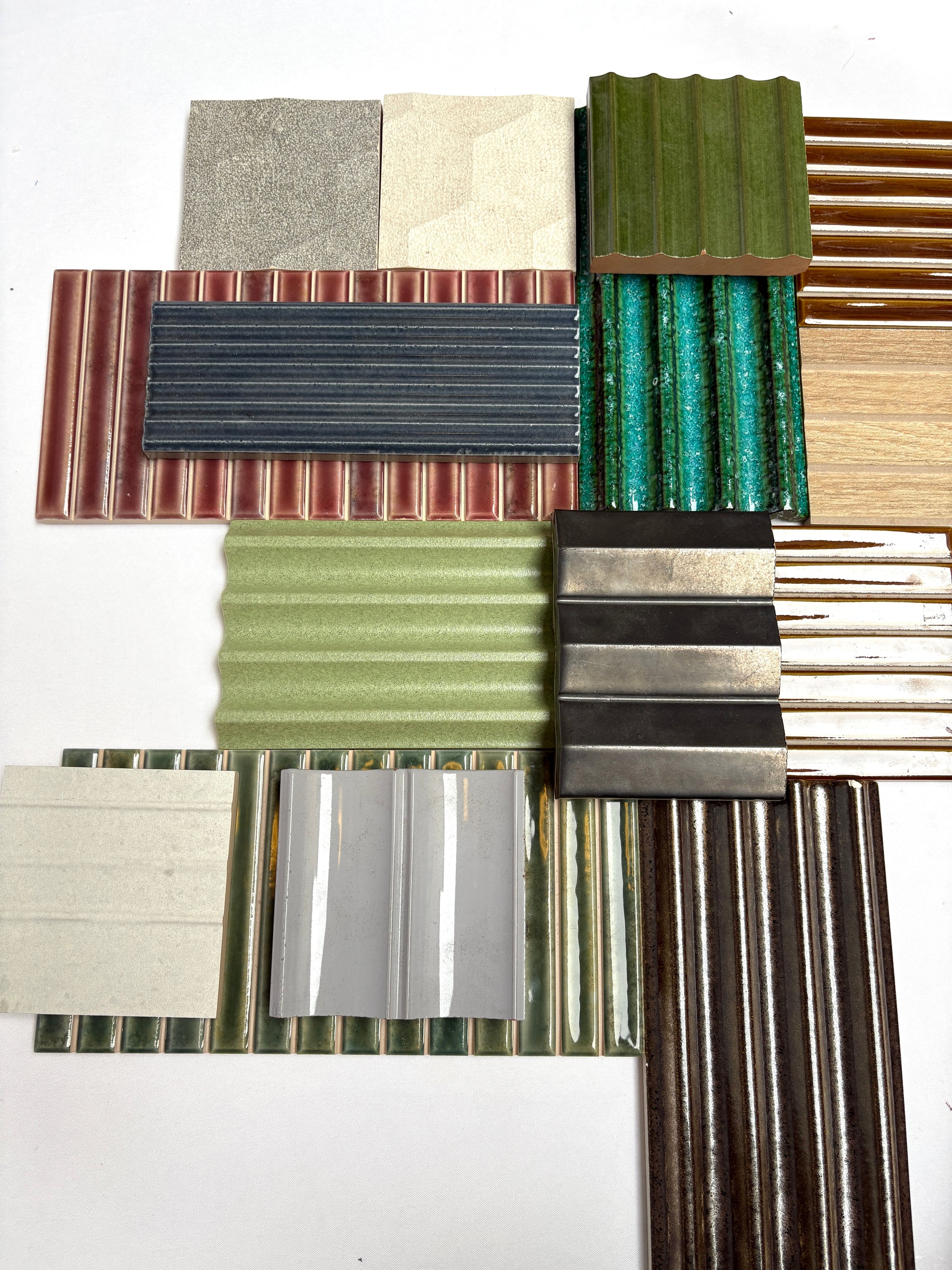 Assorted decorative textured tiles displayed on a plain white background.