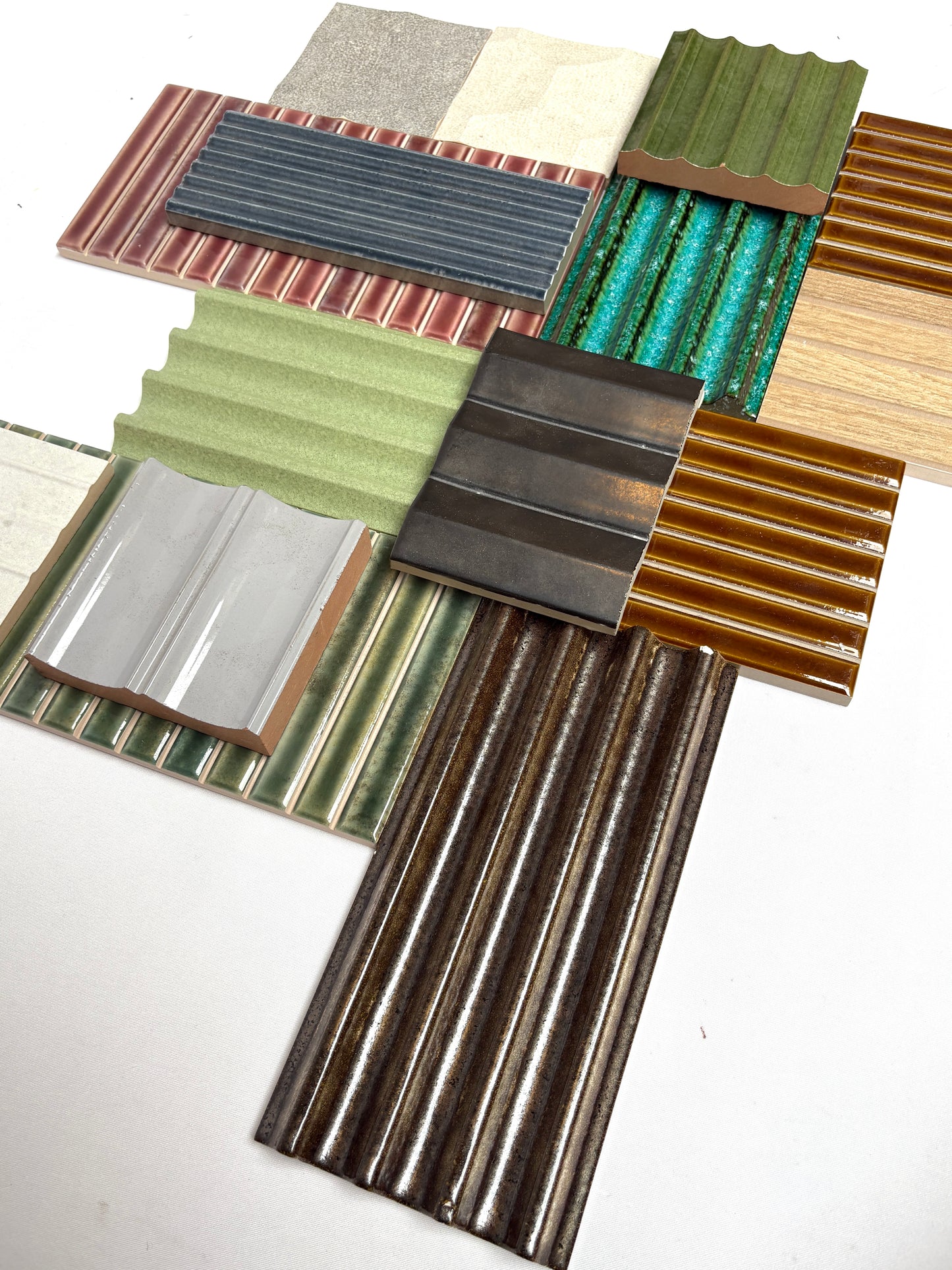 Variety of textured tile samples from a mixed bundle on white.