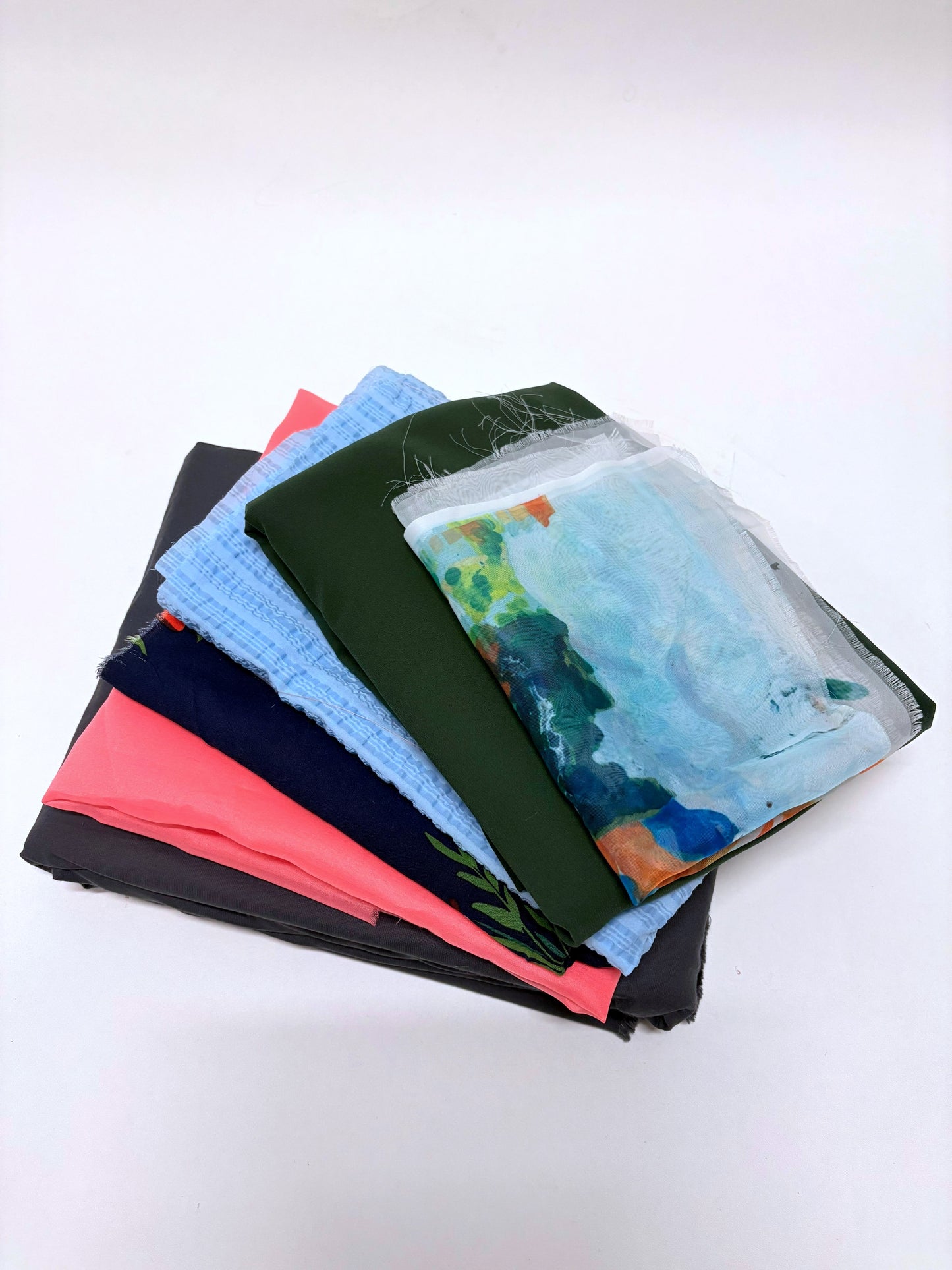 Close-up view shows fabric pieces in different colours and prints