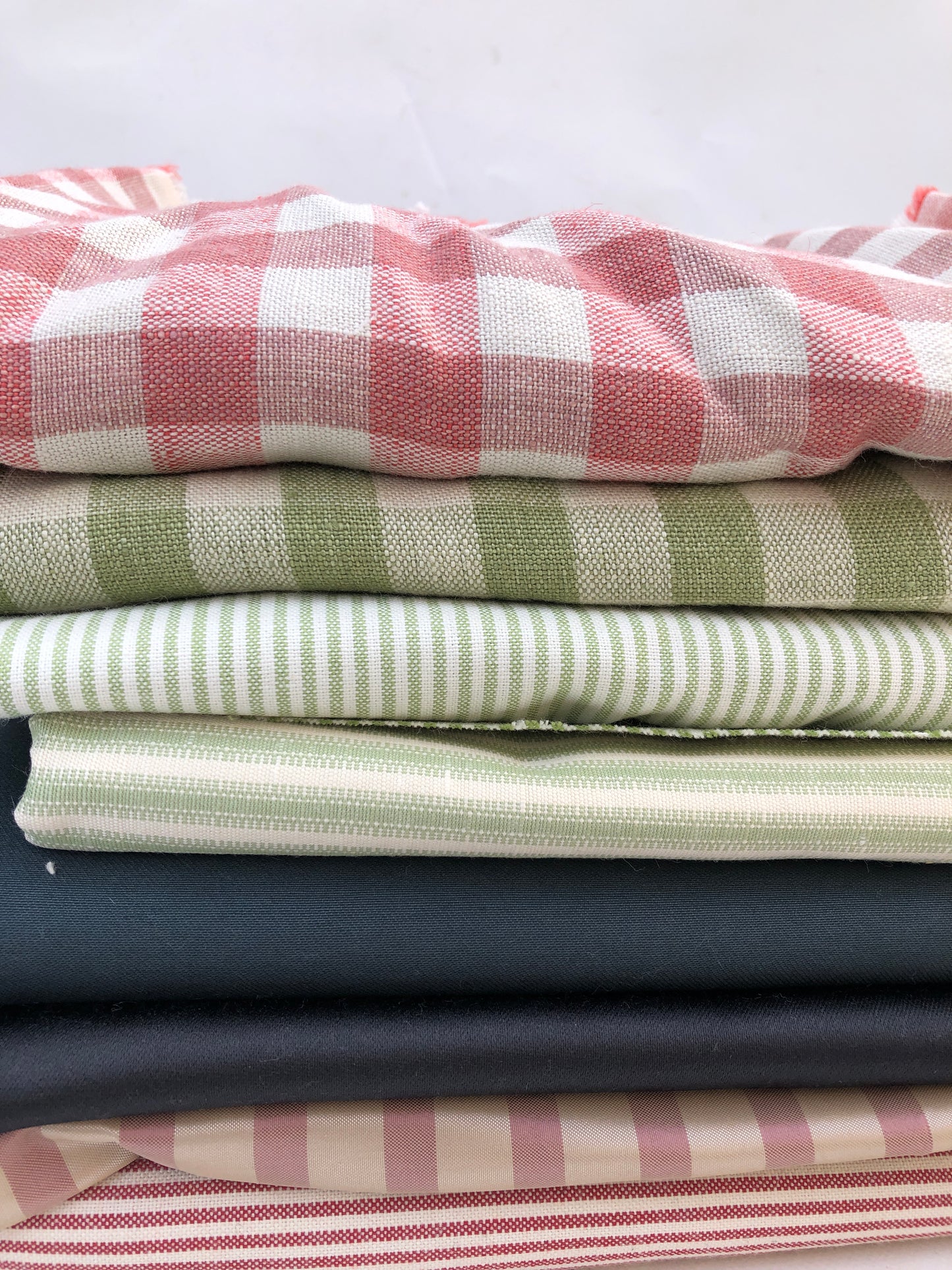 A checked fabric piece is laid flat on a white background