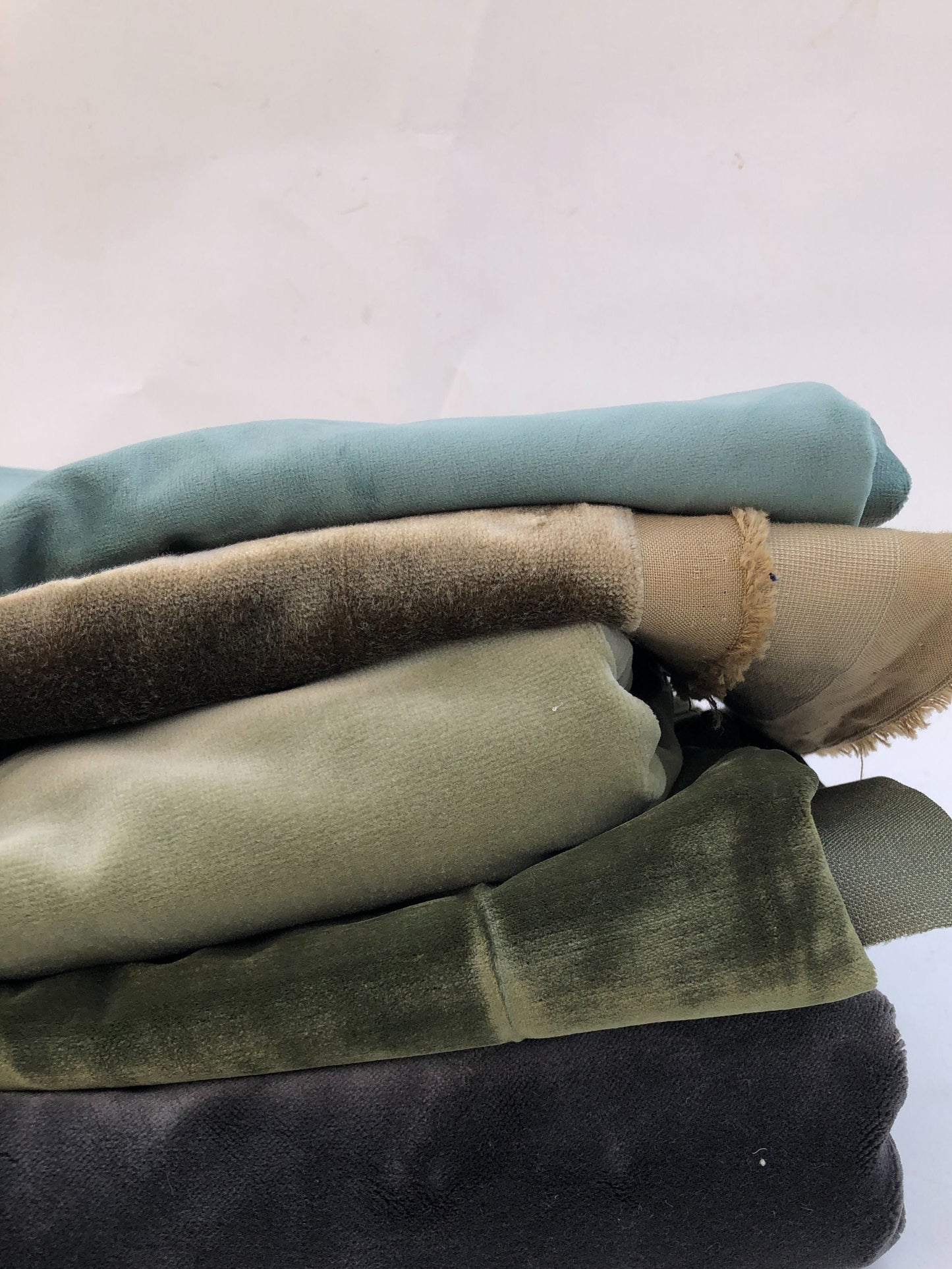 Velvet fabric pieces are laid flat in a close-up view