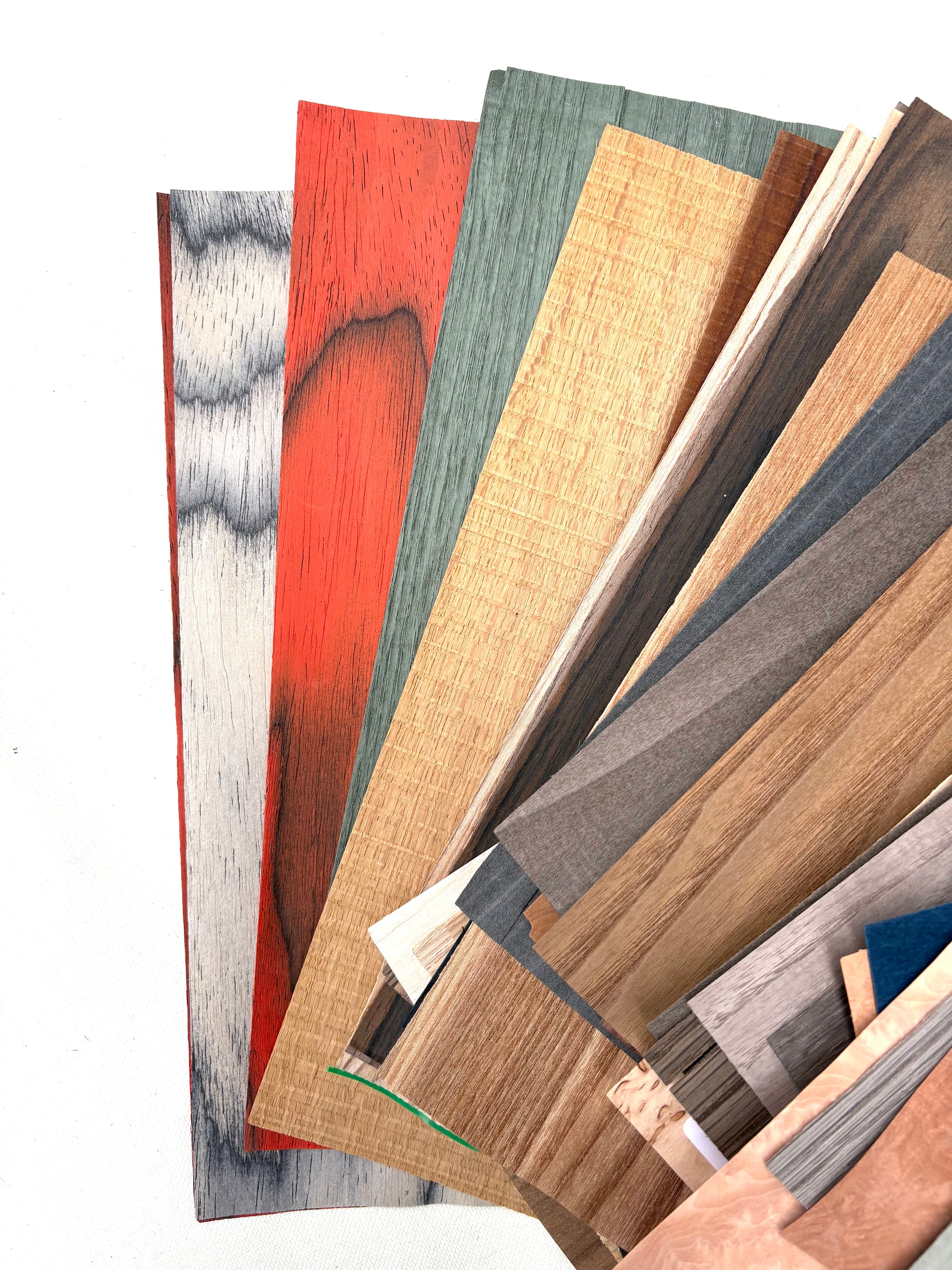 Wood-effect sample sheets are fanned out on a white background