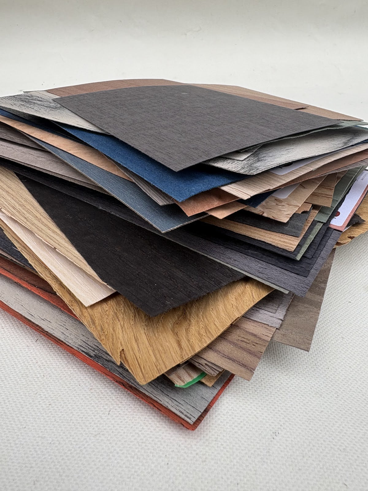 Mixed sheet samples are stacked in layered piles and close-up views
