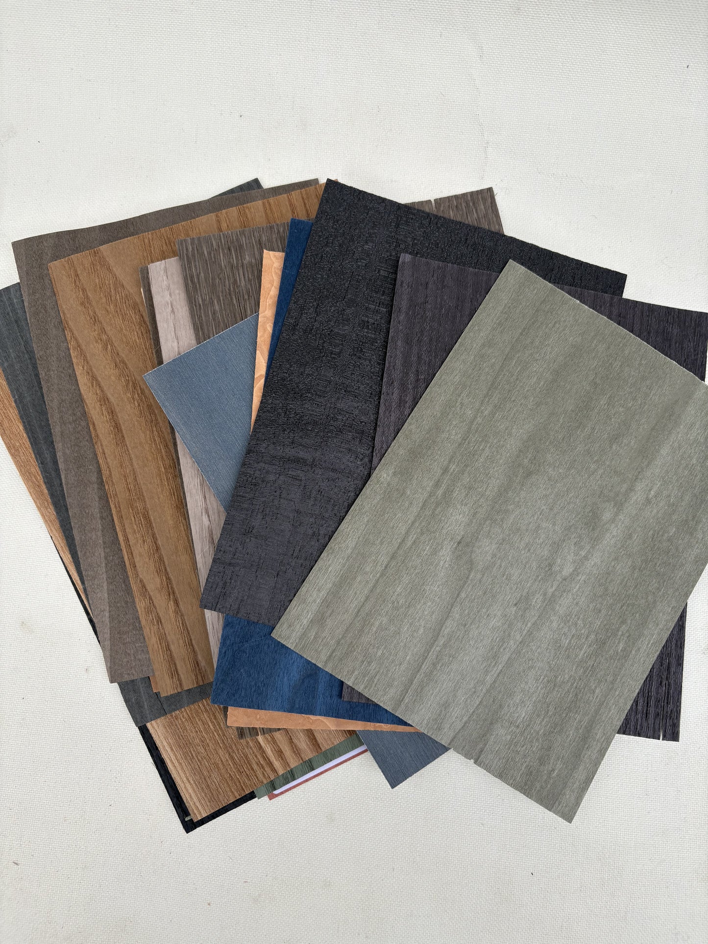 Thin sample sheets are arranged in grouped stacks on a white surface