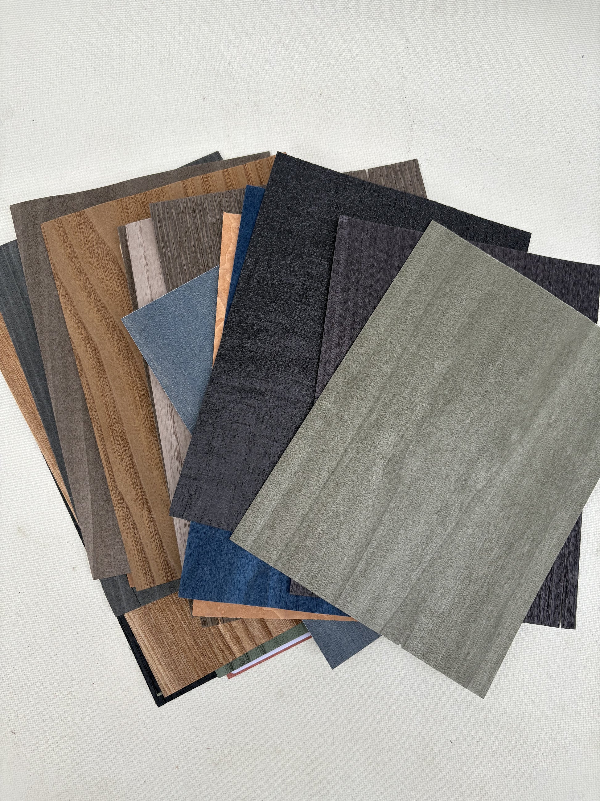 Thin sample sheets are arranged in grouped stacks on a white surface