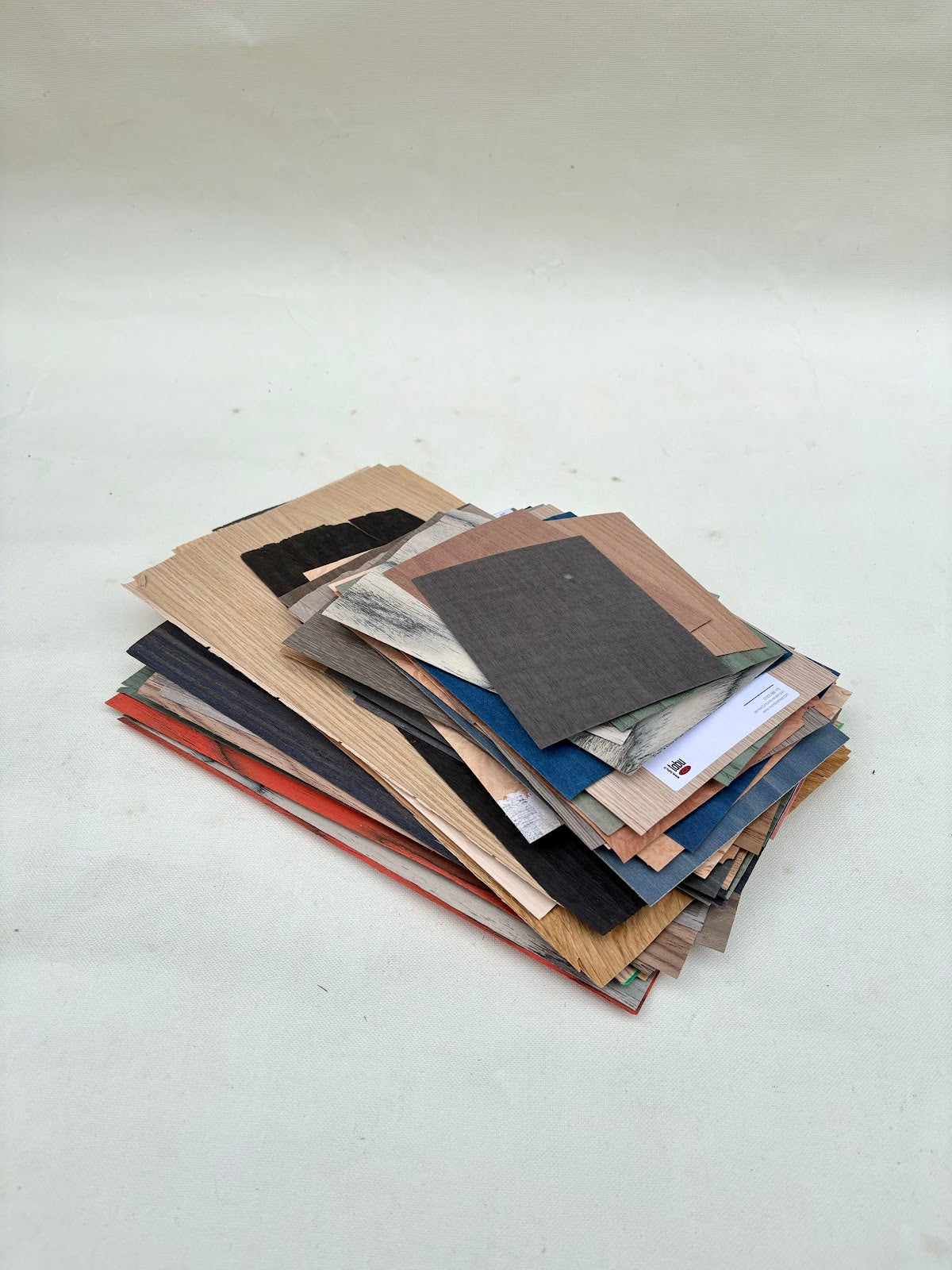 Mixed sheet samples are stacked in layered piles and close-up views