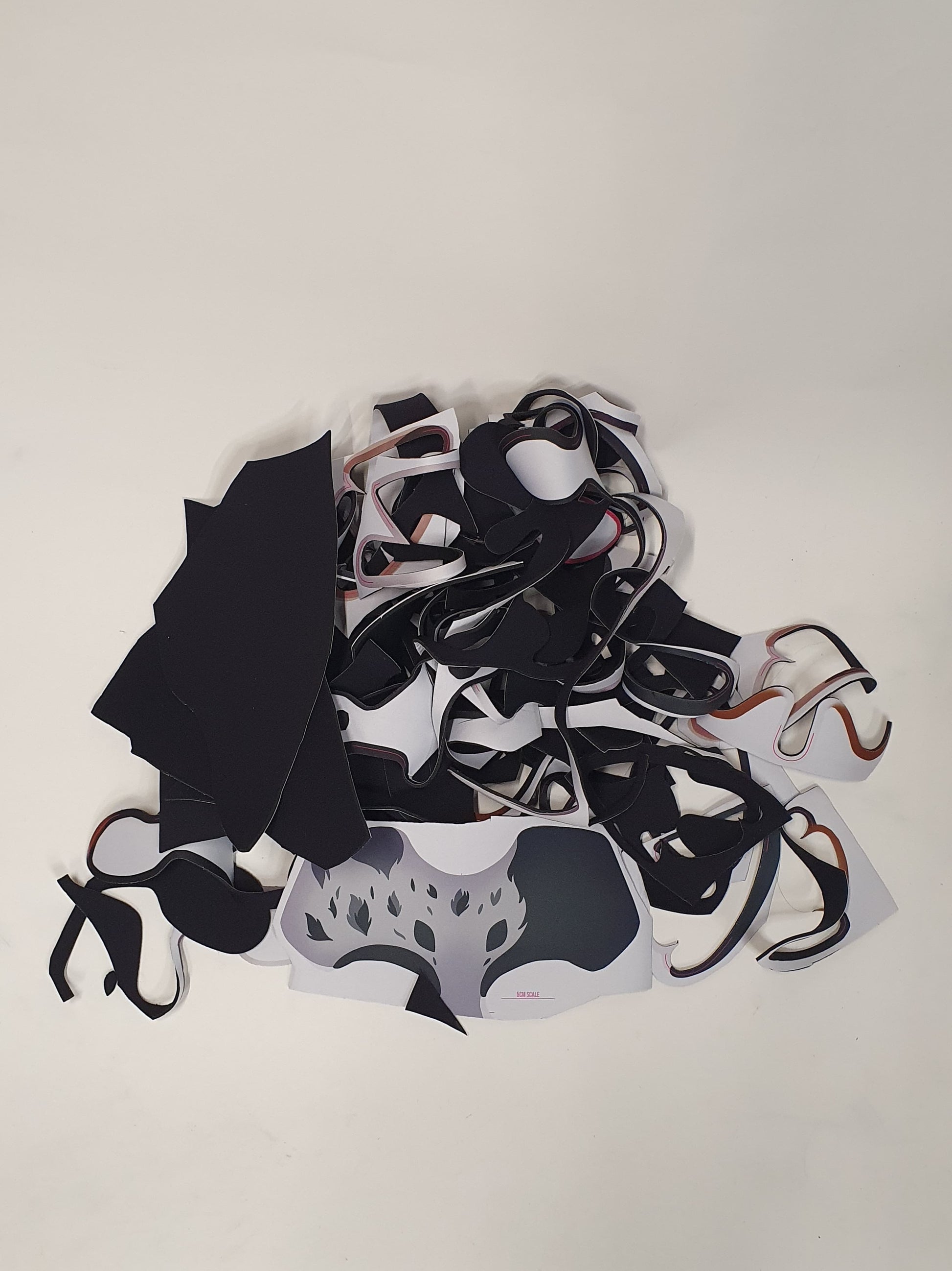 Mixed cut material pieces are shown in a loose layered bundle