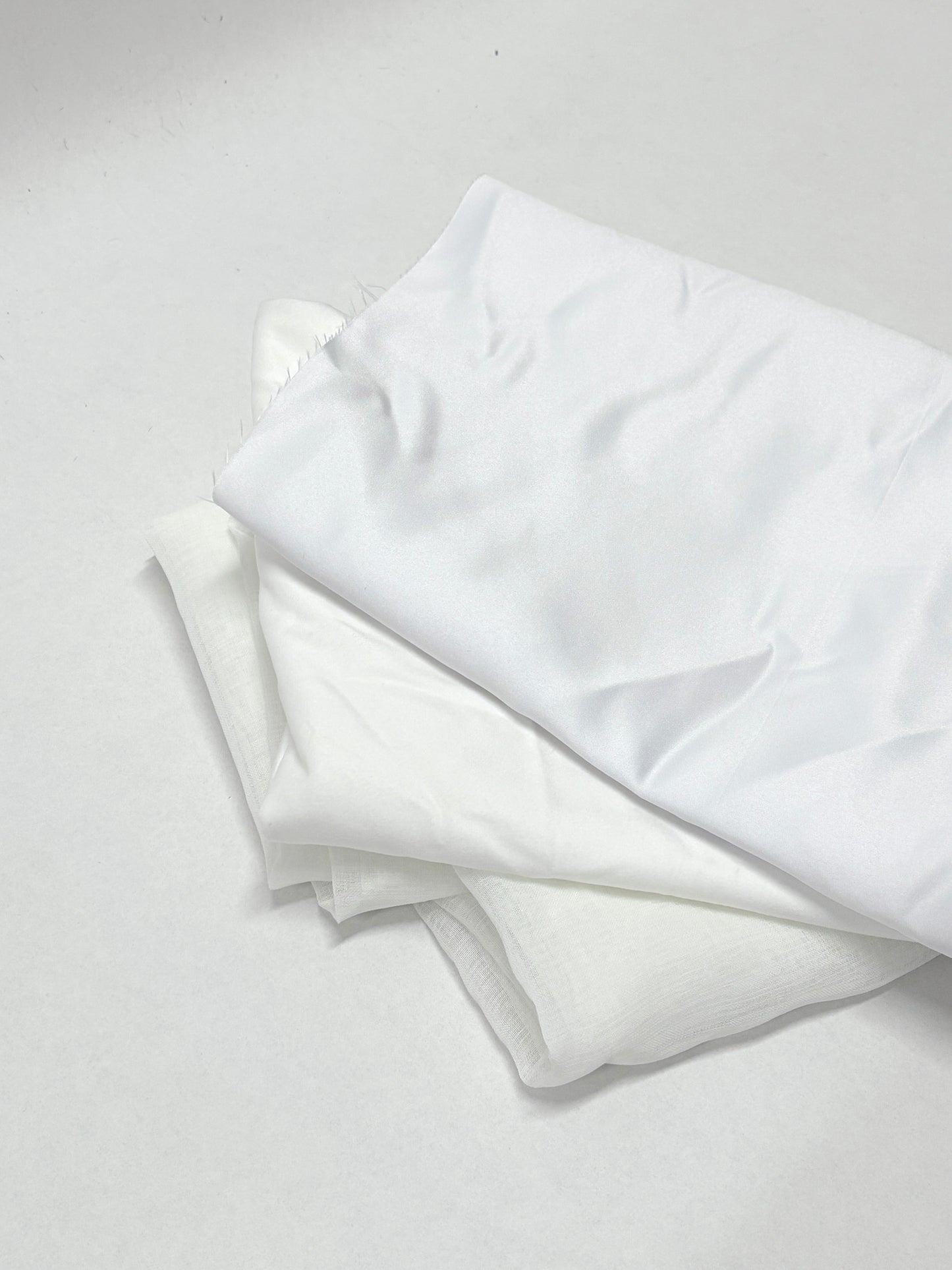 White fabric layers are shown folded in a close-up view