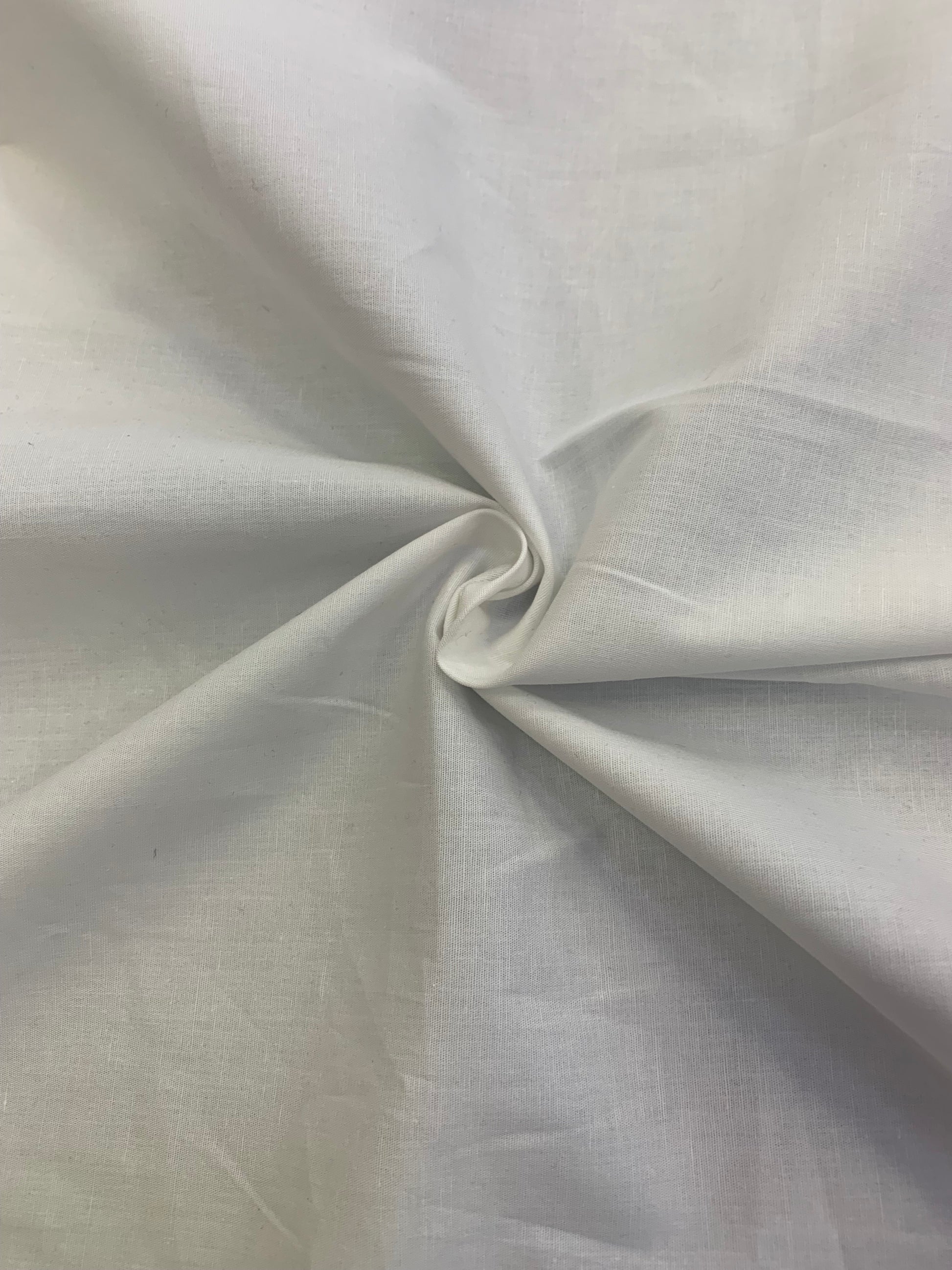 White cotton fabric is gathered into a small central fold