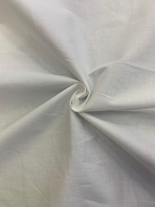 White cotton fabric is gathered into a small central fold