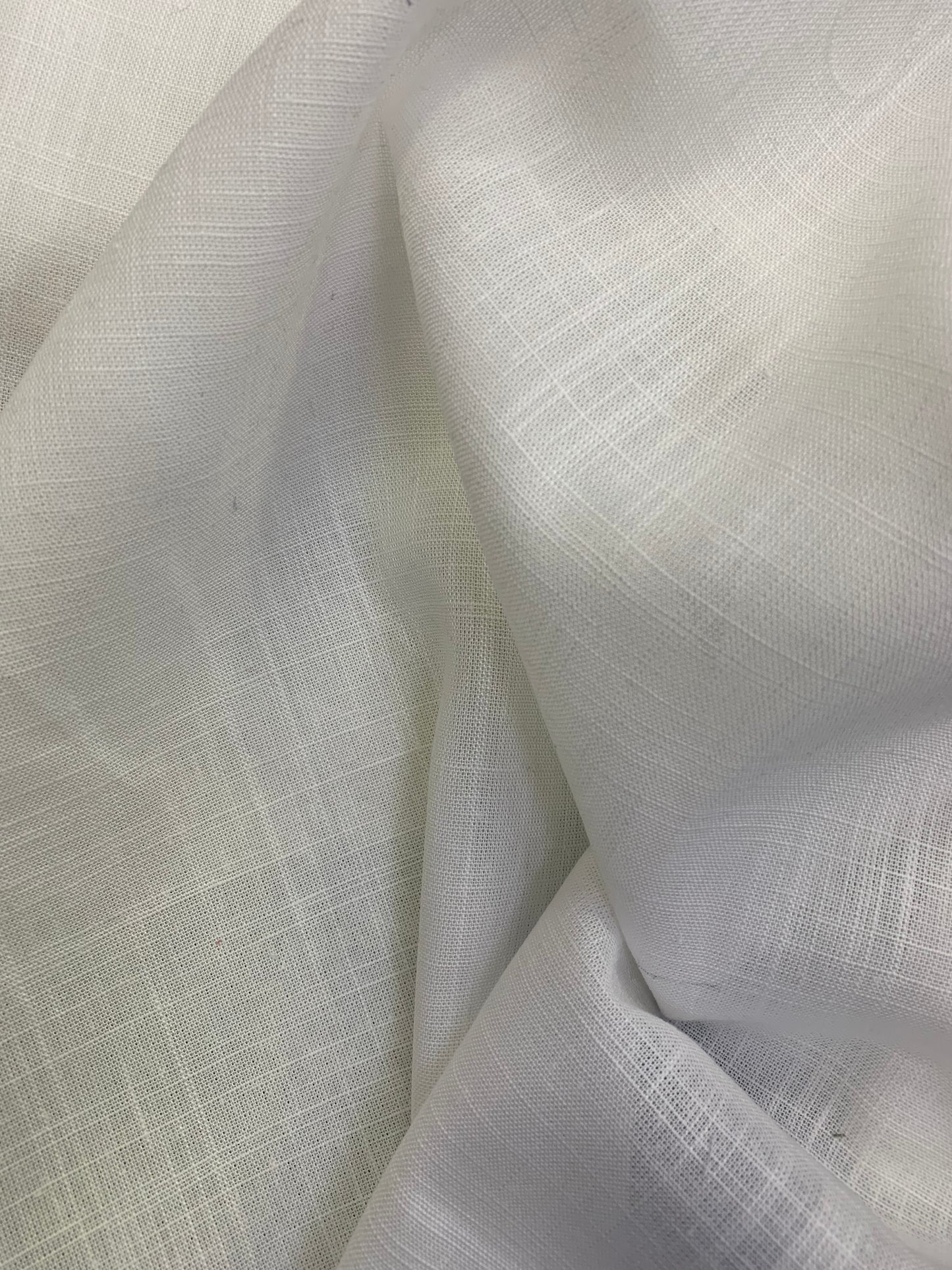 White viscose linen deadstock fabric shown in a softly folded close-up.