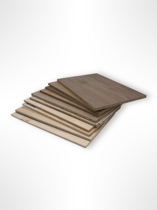 Wood sample boards are stacked in a neat pile on white
