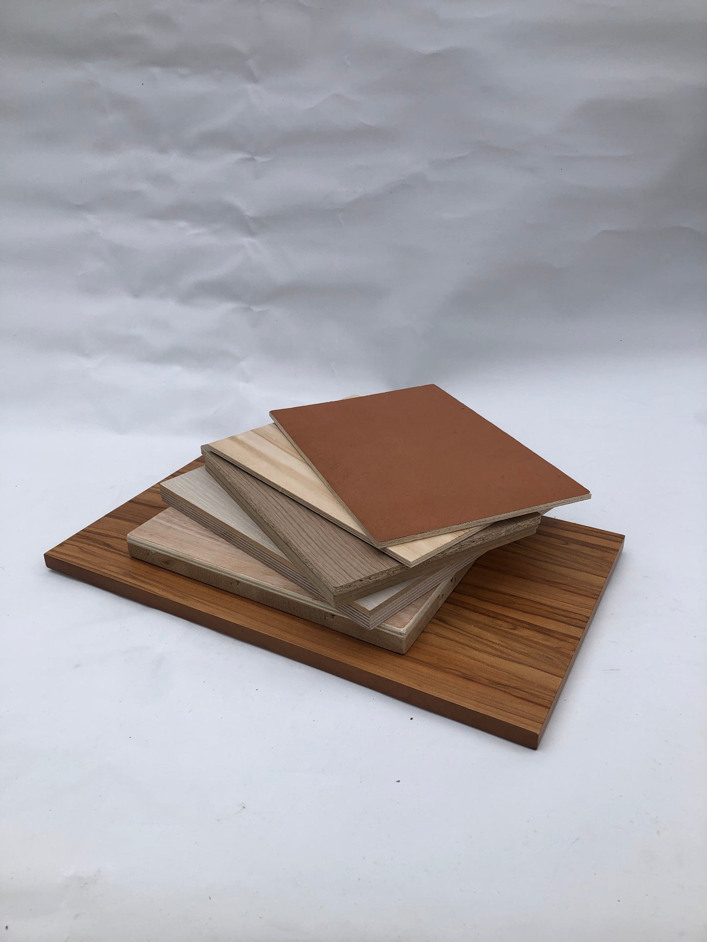Square wood-effect panels are layered in a fan-like stack
