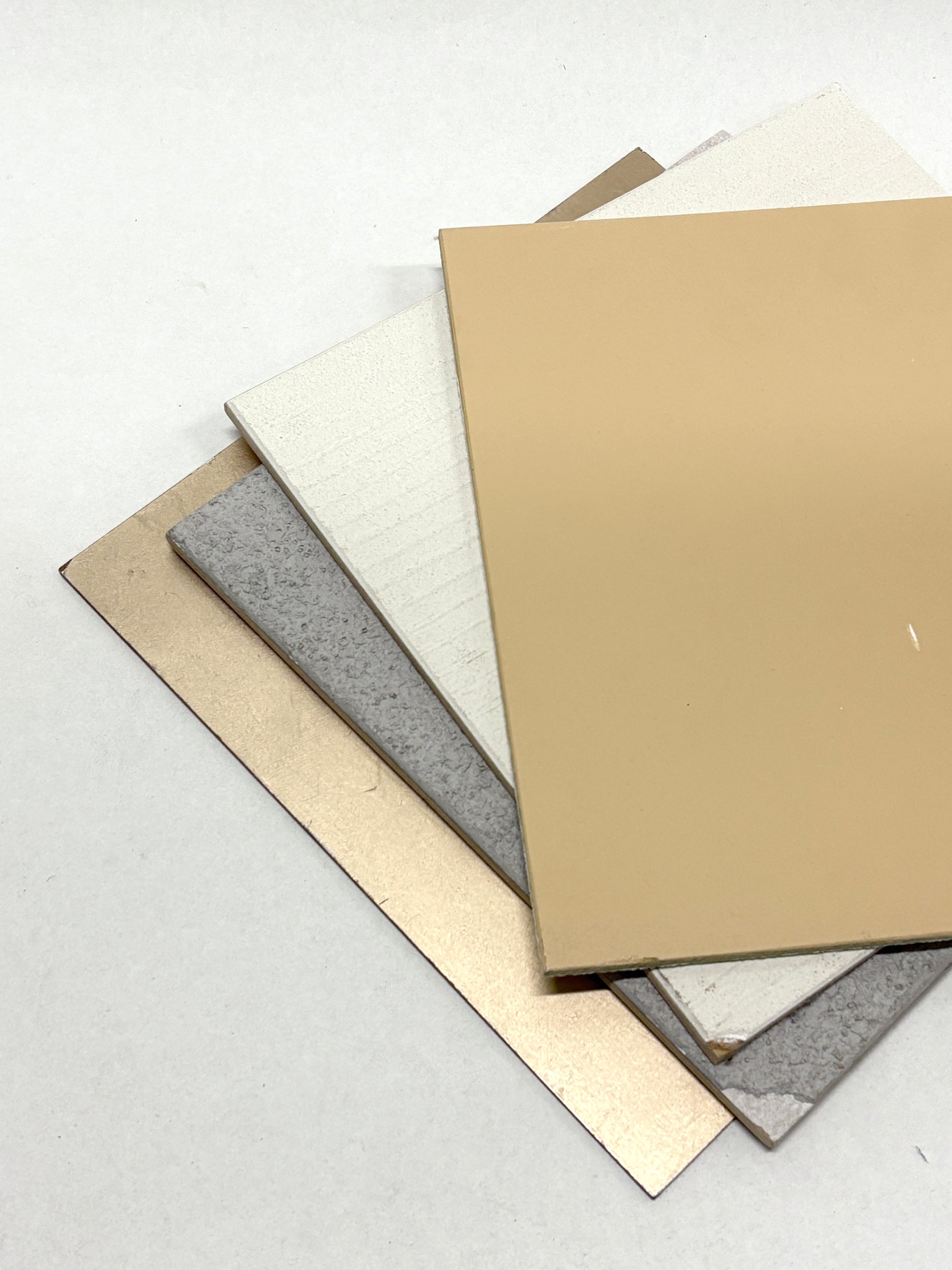Flat sample sheets are shown in different colours, textures, and finishes