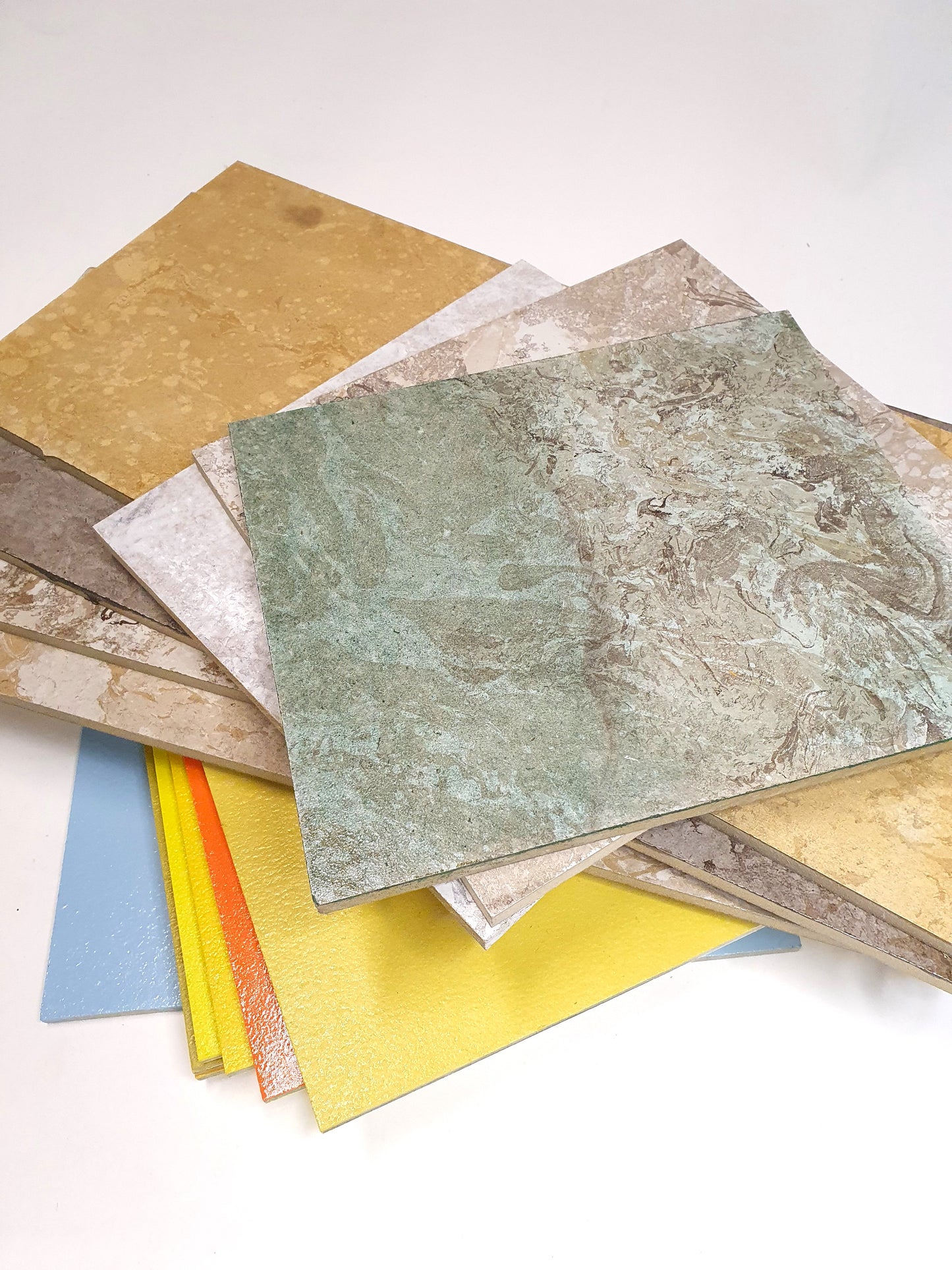 Flat sample sheets are shown in different colours, textures, and finishes