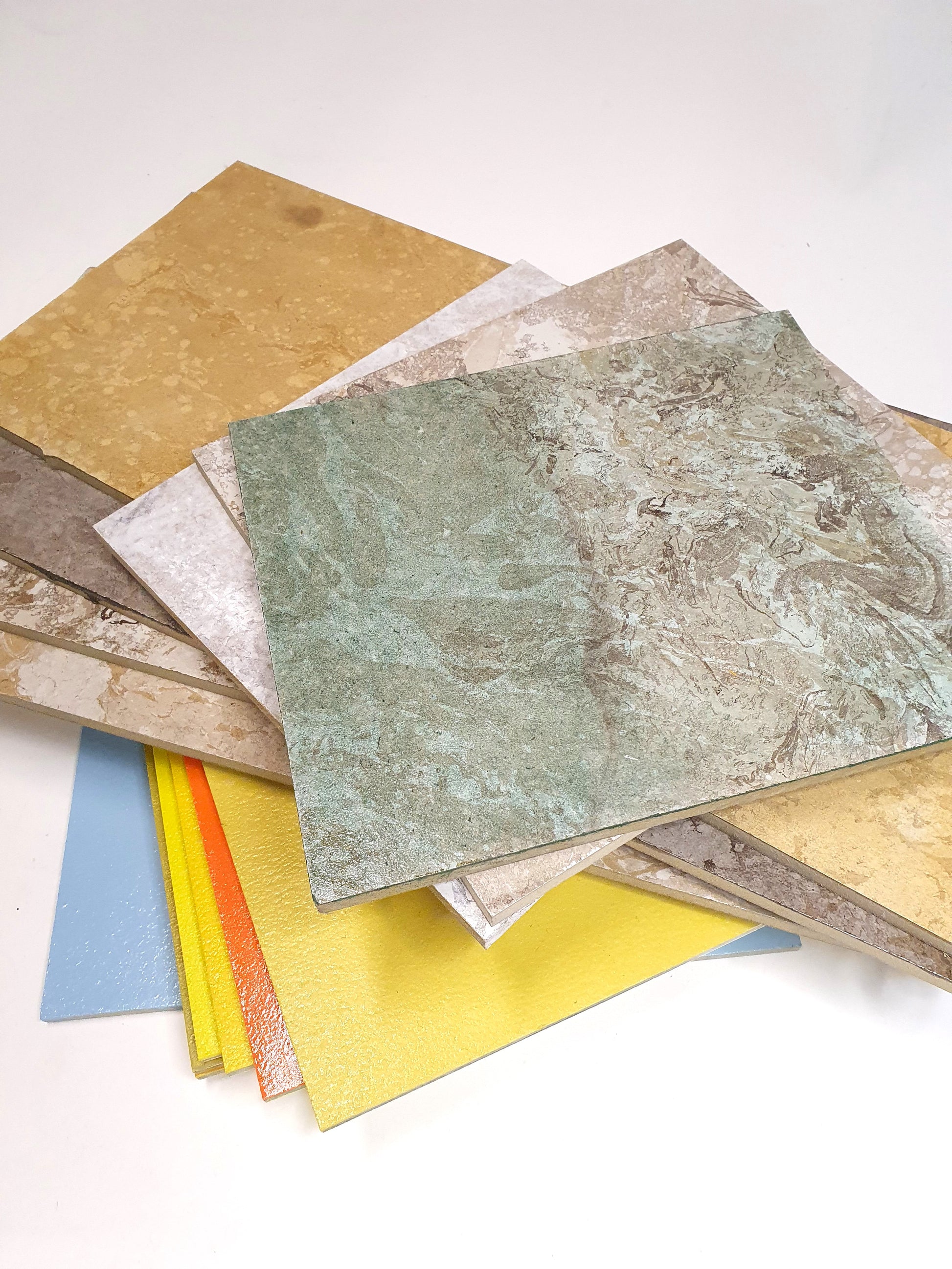 Flat sample sheets are shown in different colours, textures, and finishes