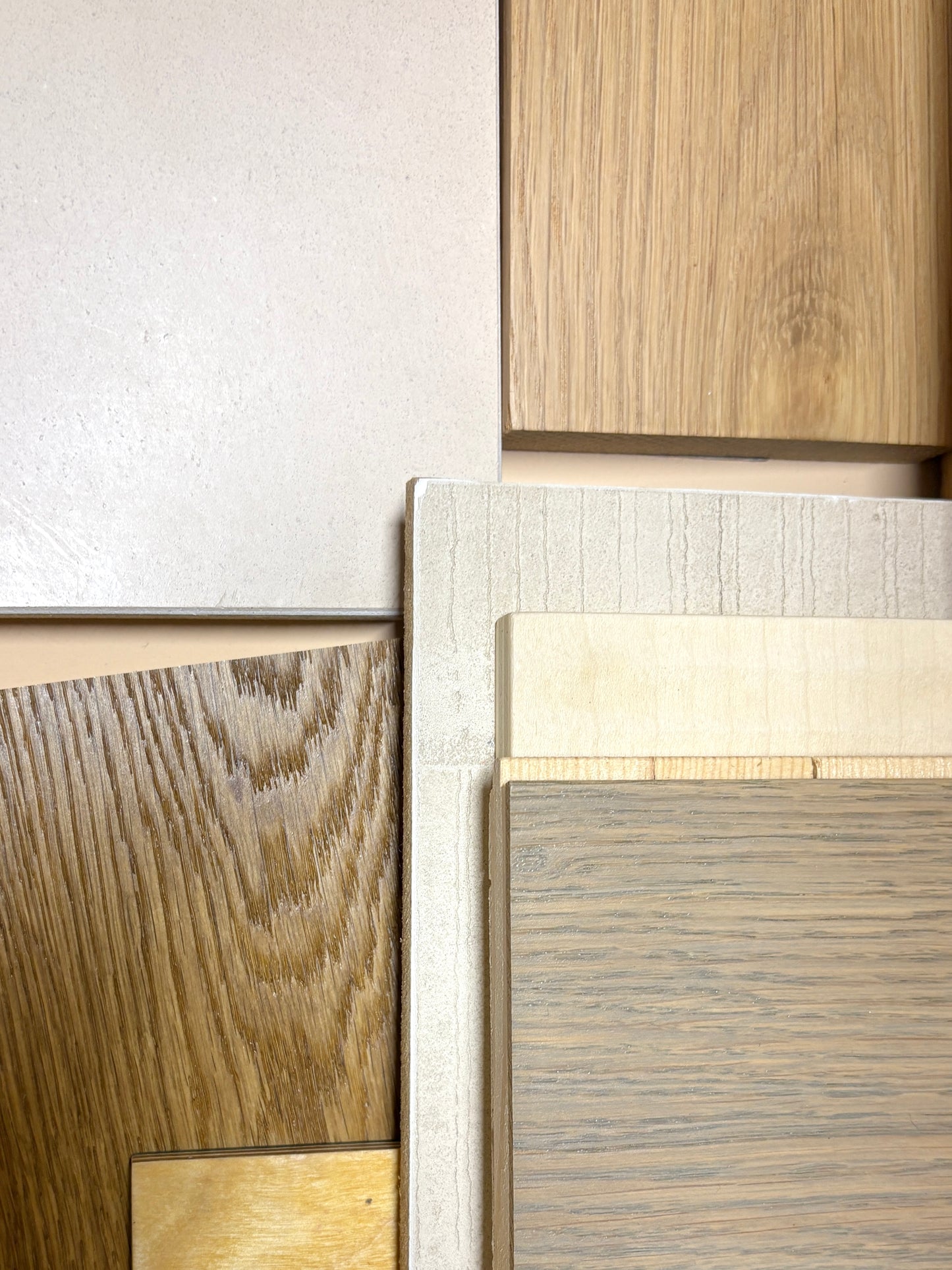 Close-up of wooden panels with different finishes on a neutral background