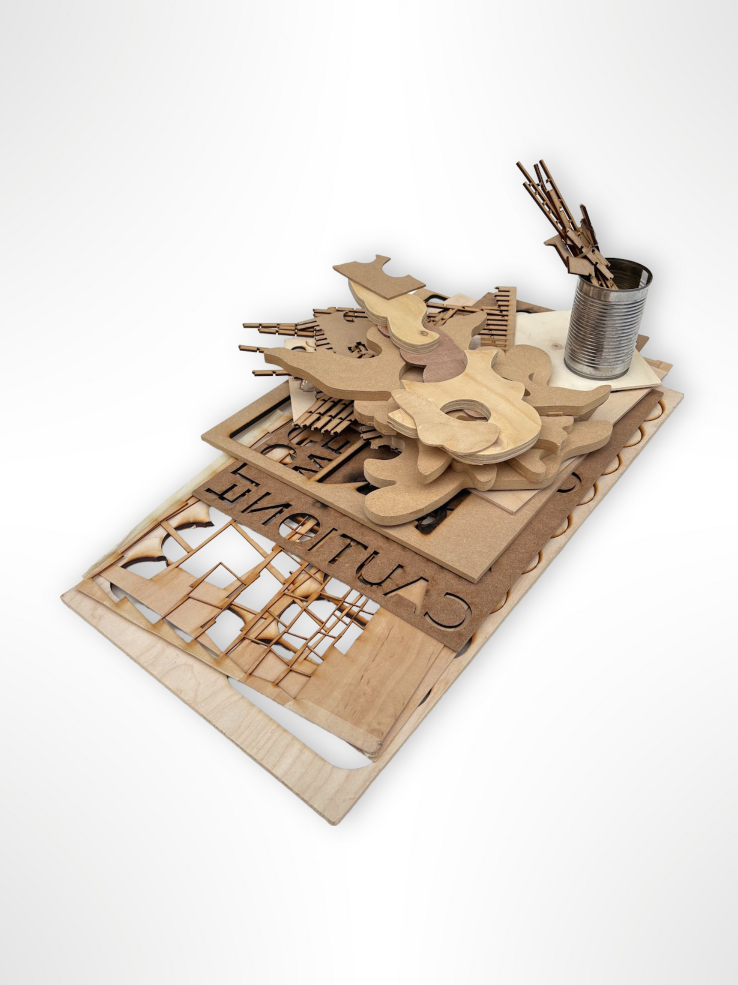 Laser-cut wood shapes and panels are stacked on a white background.