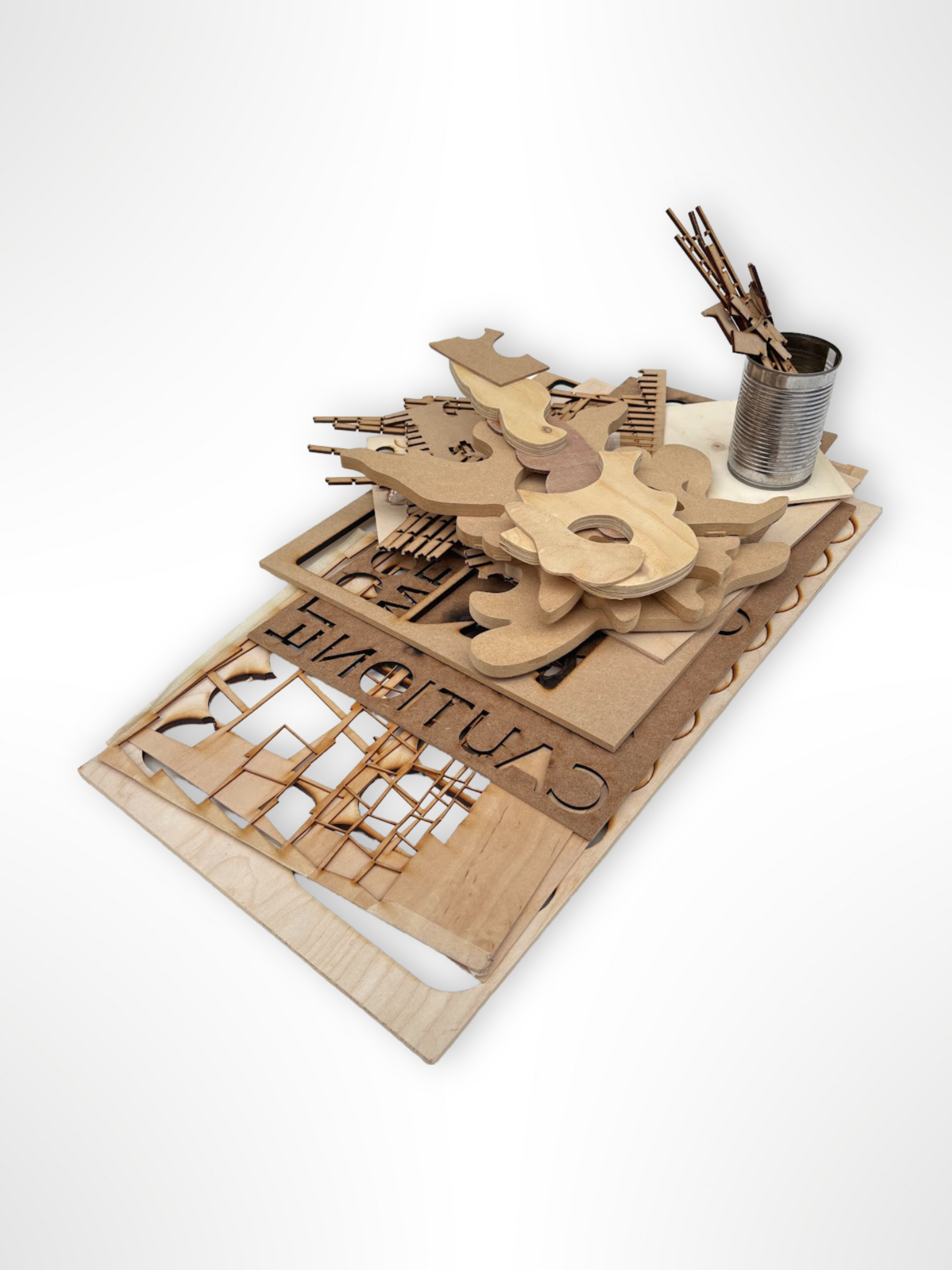 Laser-cut wood shapes and panels are stacked on a white background.