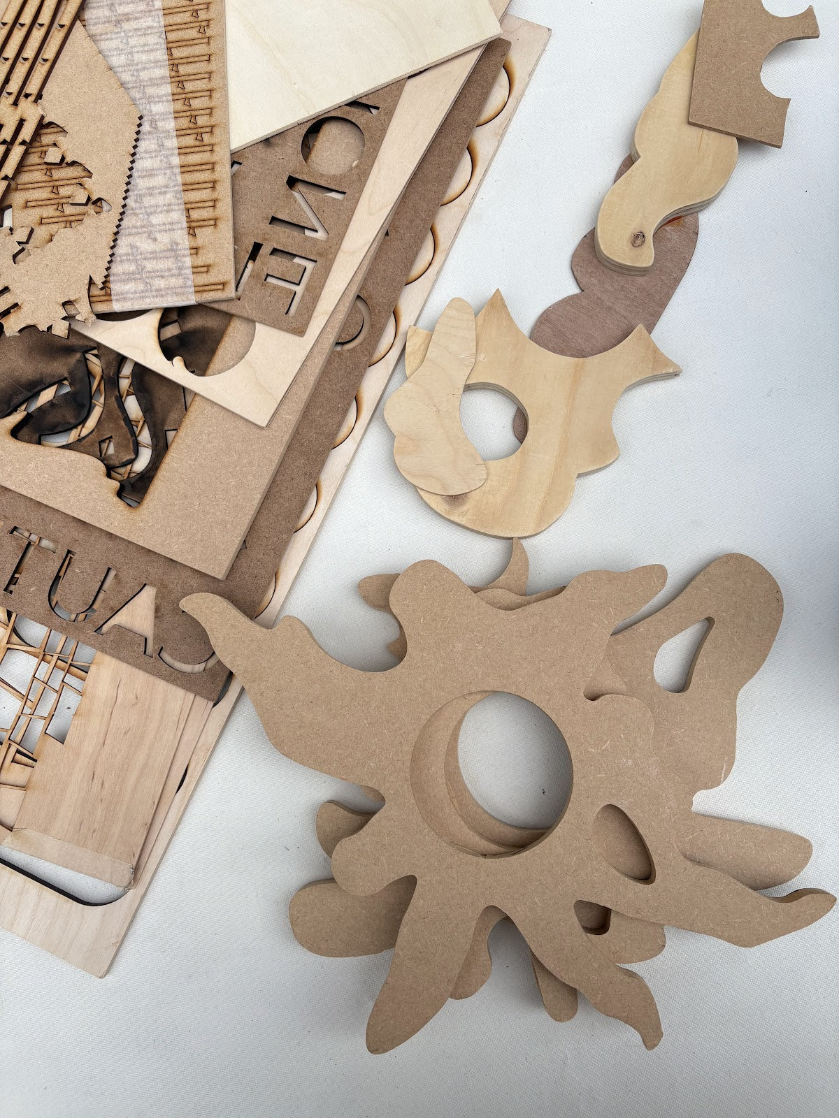 Small wooden circles and cut pieces are scattered beside a metal tin
