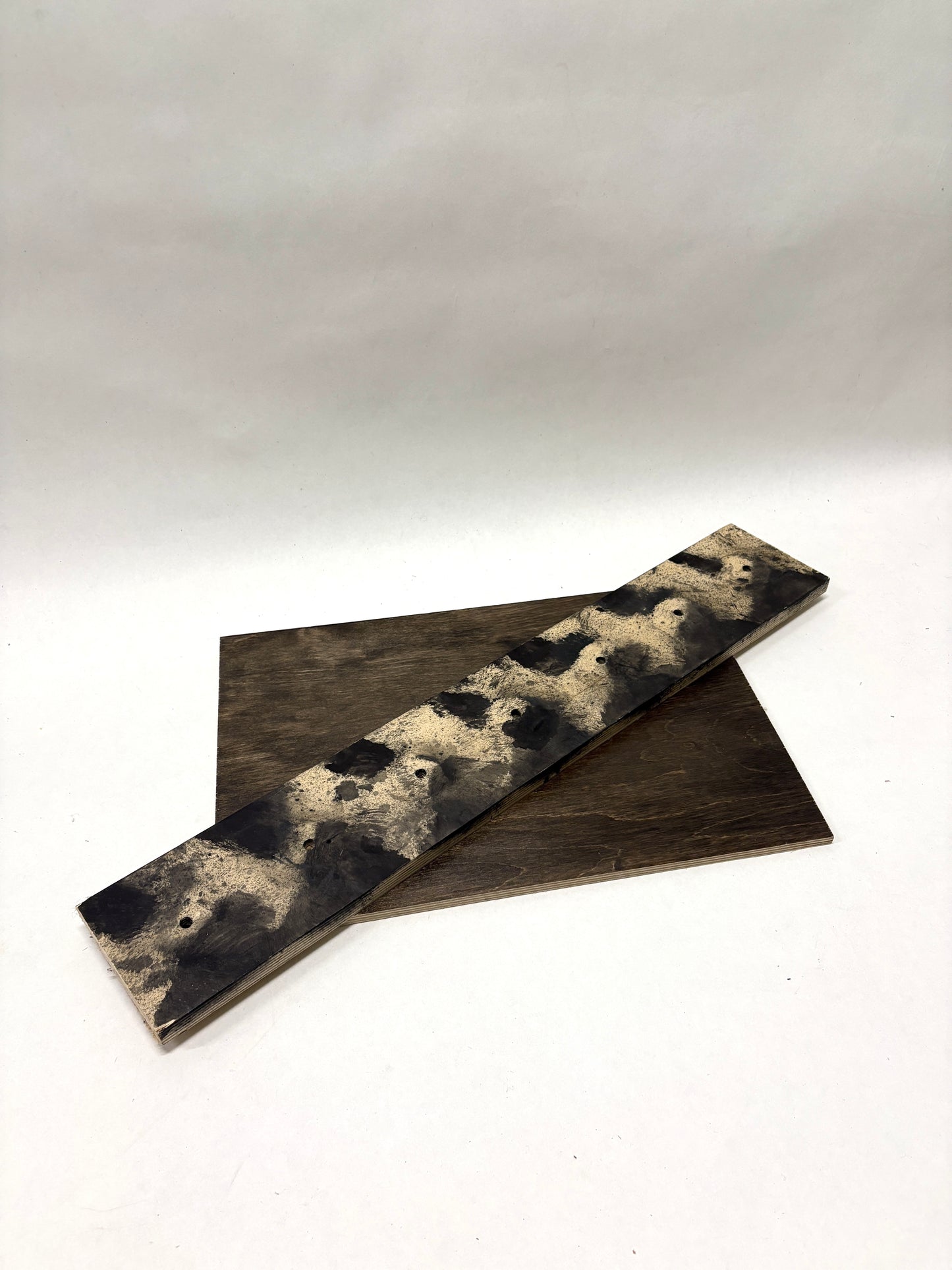 Wooden sample boards with varied finishes are shown on white