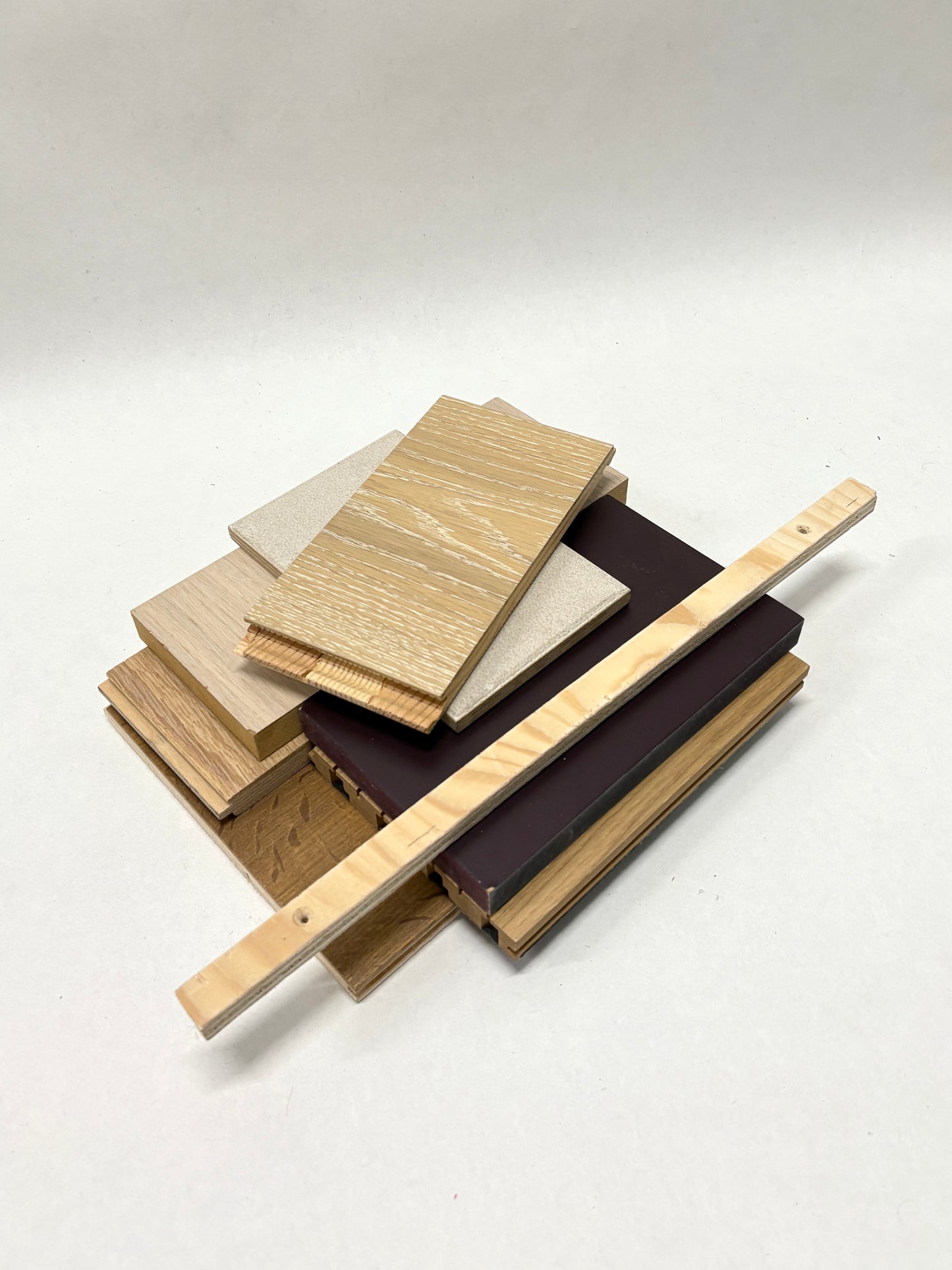     Wood sample pieces and narrow strips are arranged in a loose stack