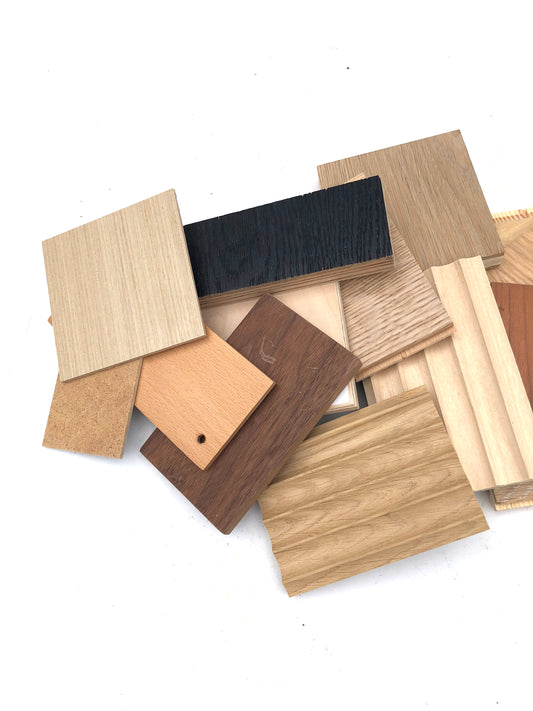 Collection of wooden samples in various colors and finishes on a white background