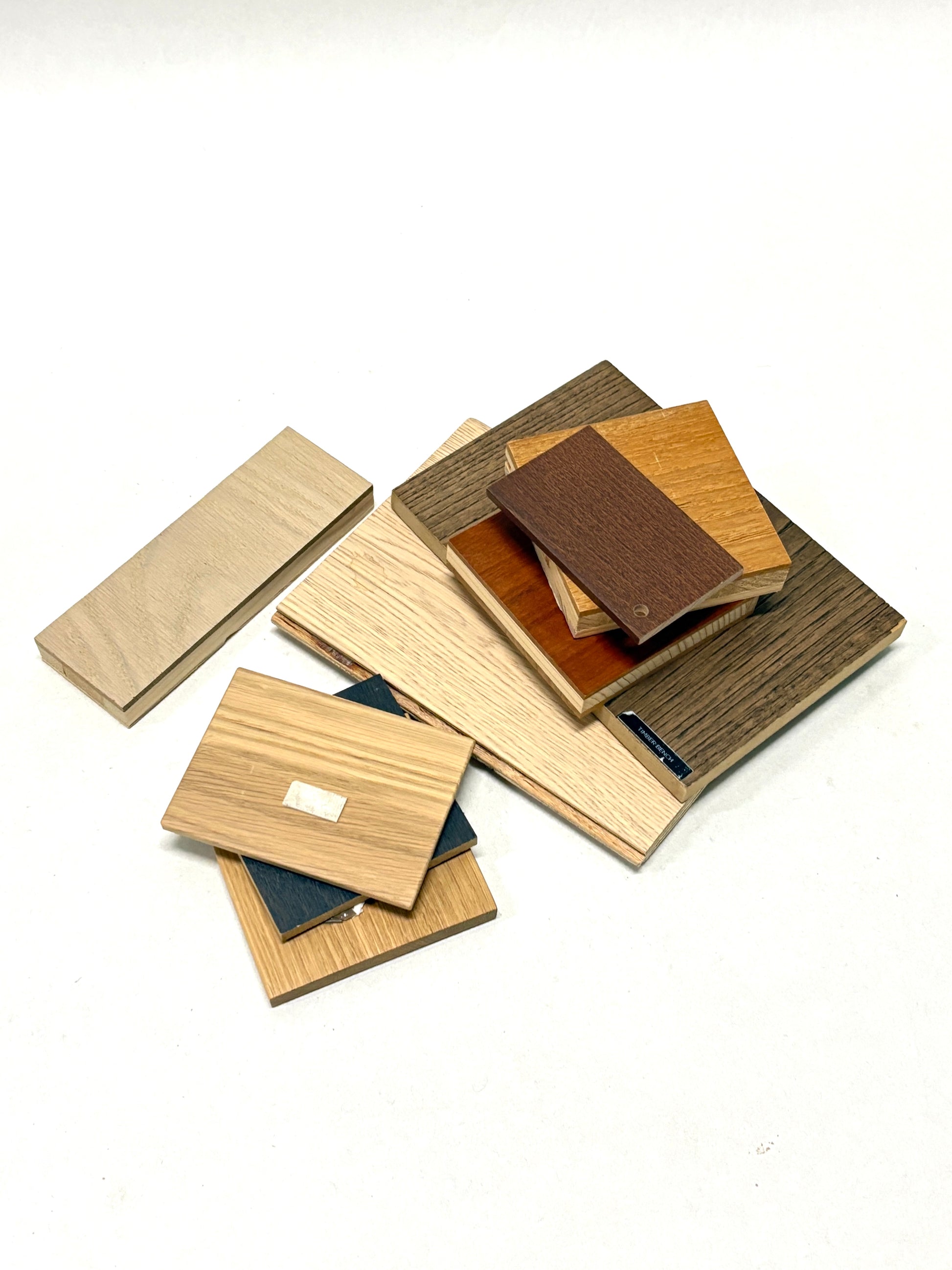 Small wood-effect boards are layered in a loose pile