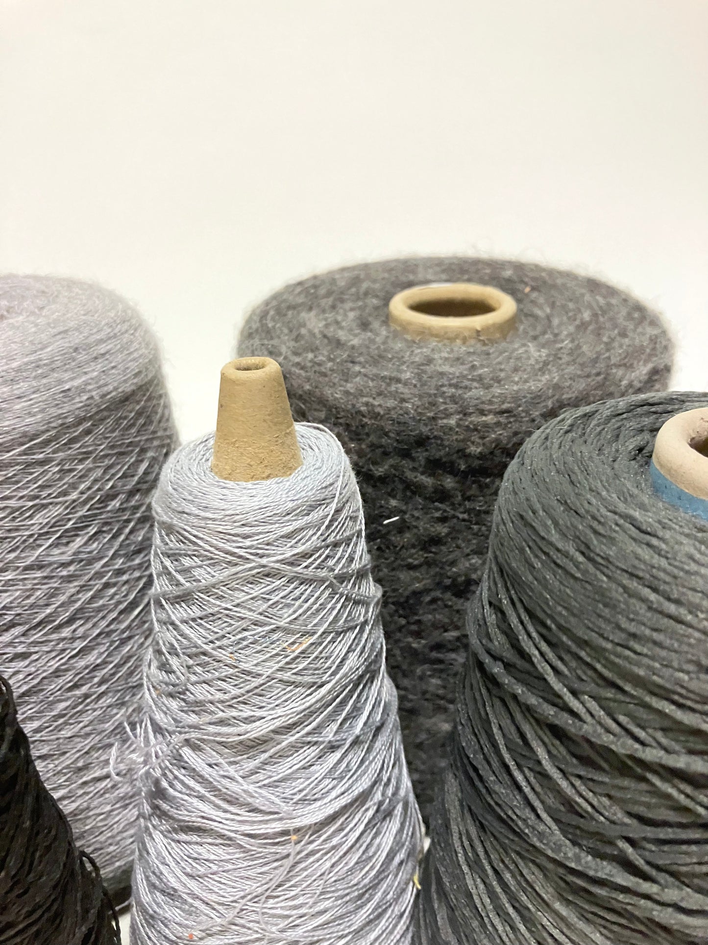 Close-up views show grey thread cones in different sizes