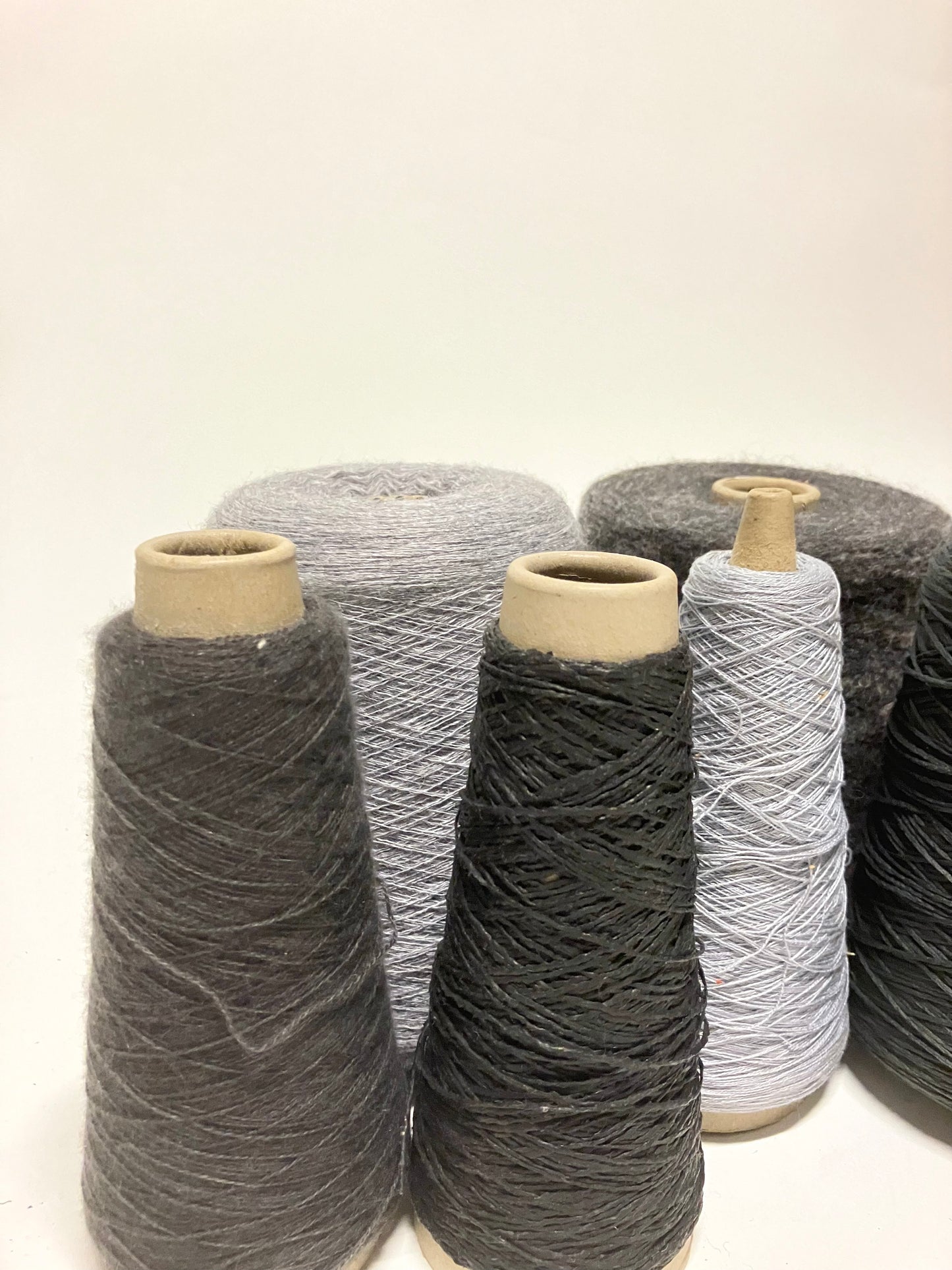 Mixed grey thread cones are shown from front and side angles
