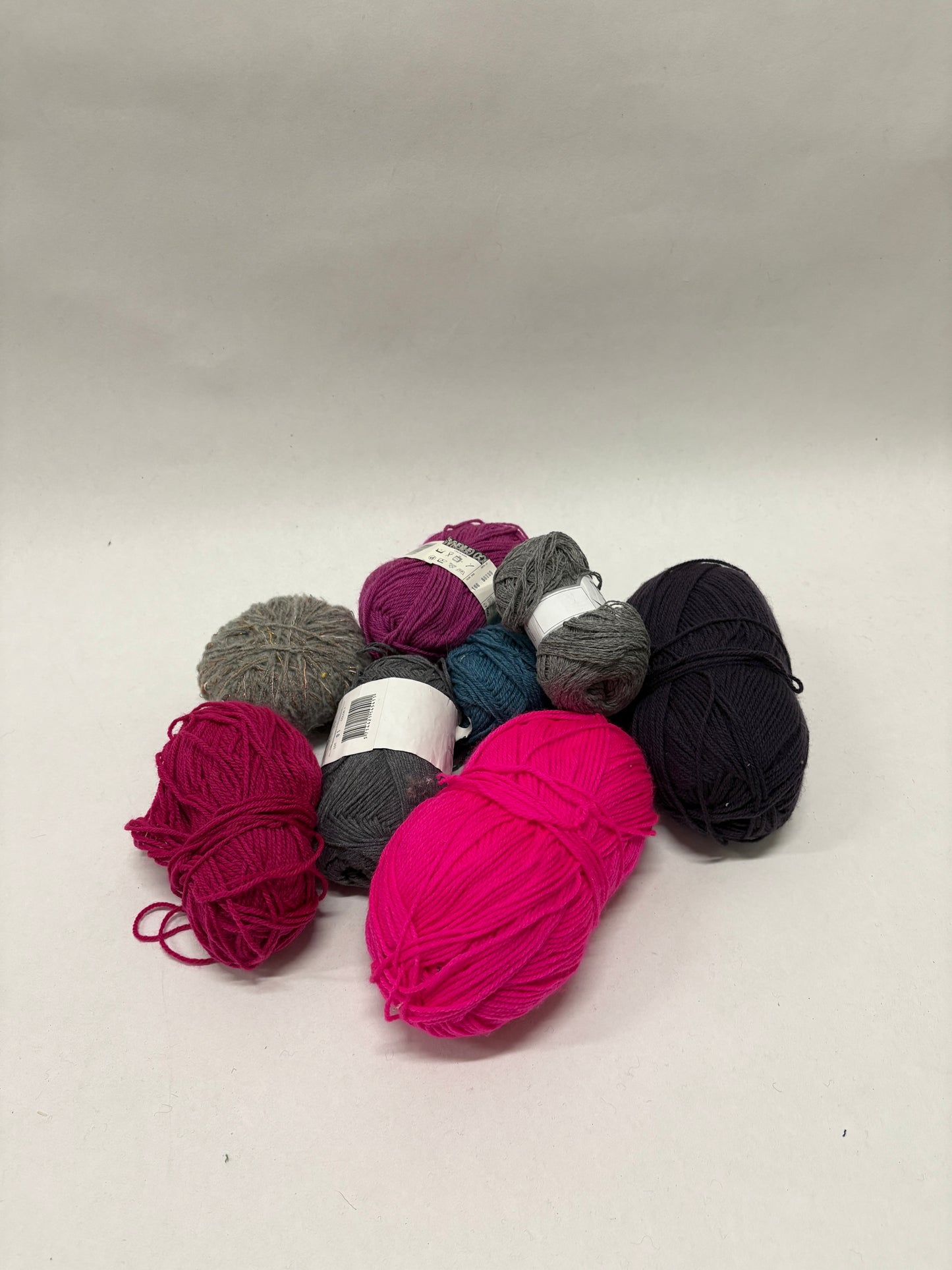 Assorted yarn in different colours is arranged in a loose pile