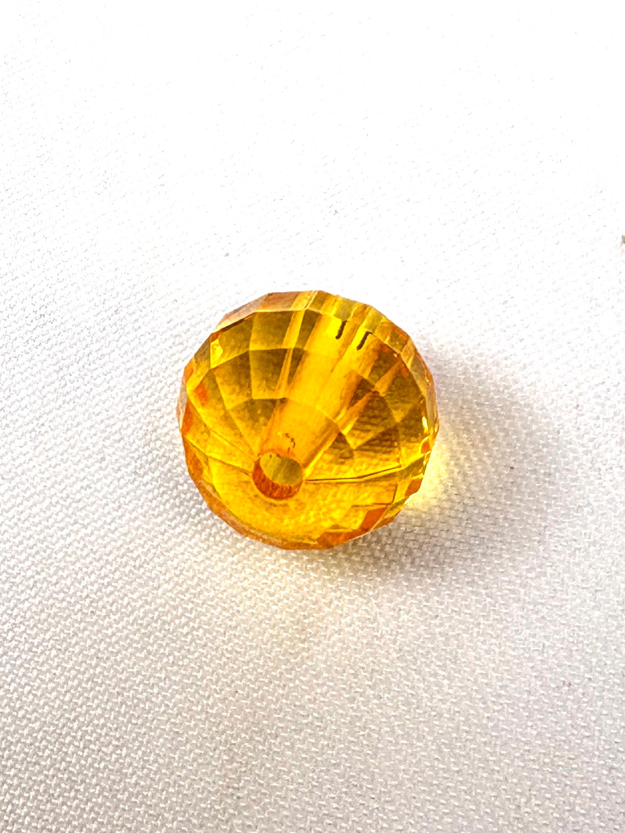 Close-up of a yellow acrylic transparent bead