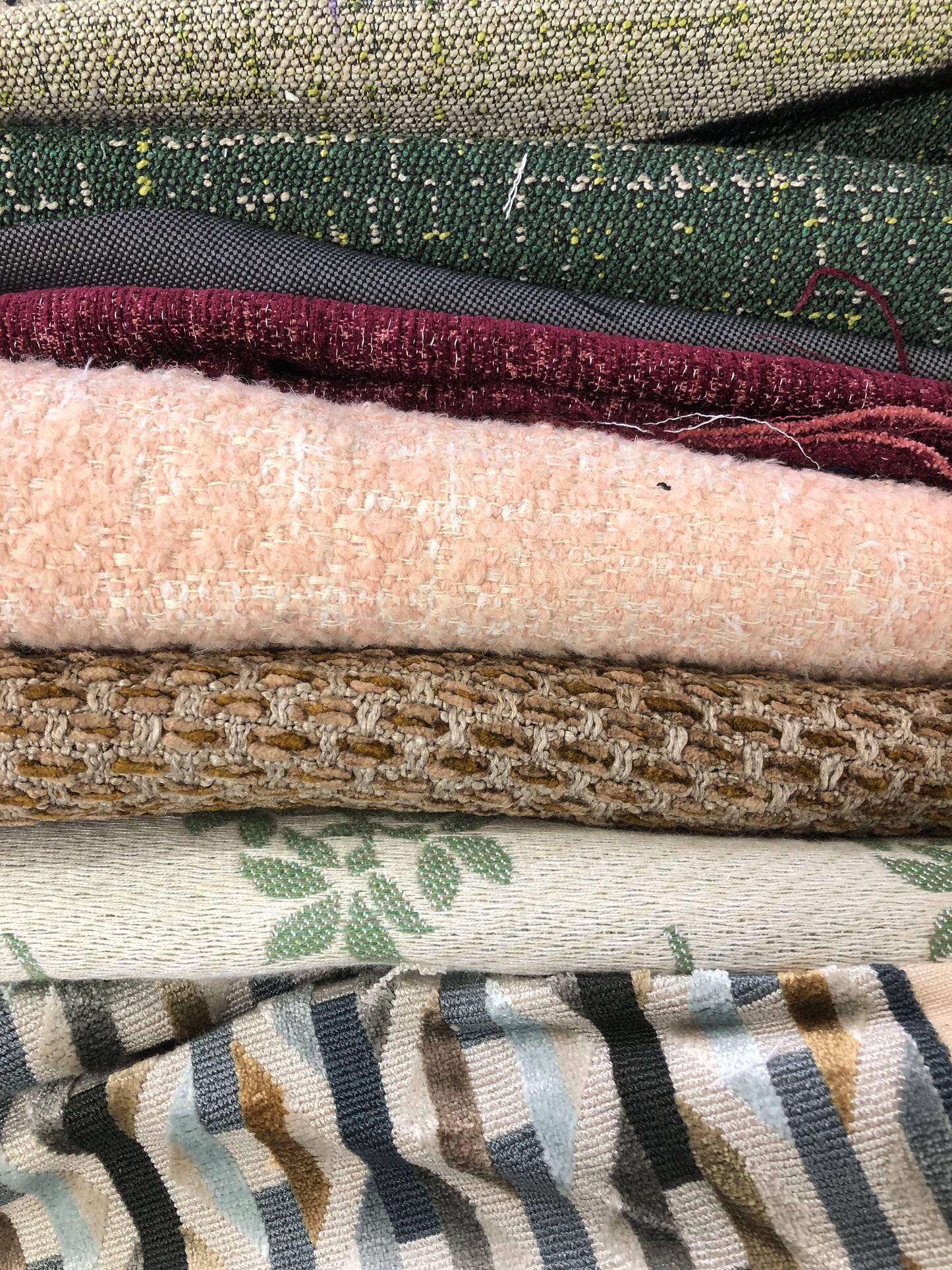 Close-up of various textured fabric samples in a patterned 