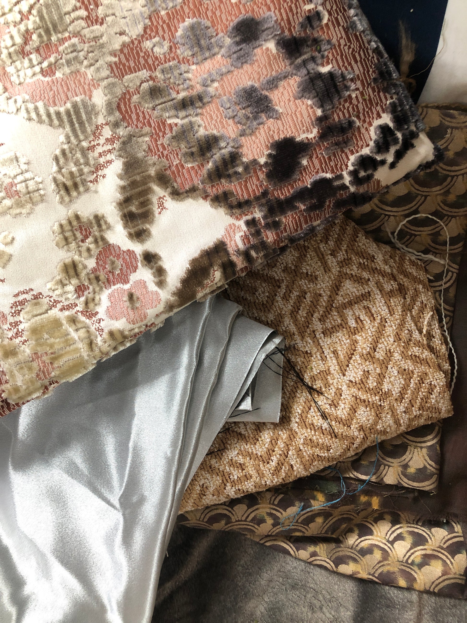 Close-up of various textured fabric samples in a patterned 