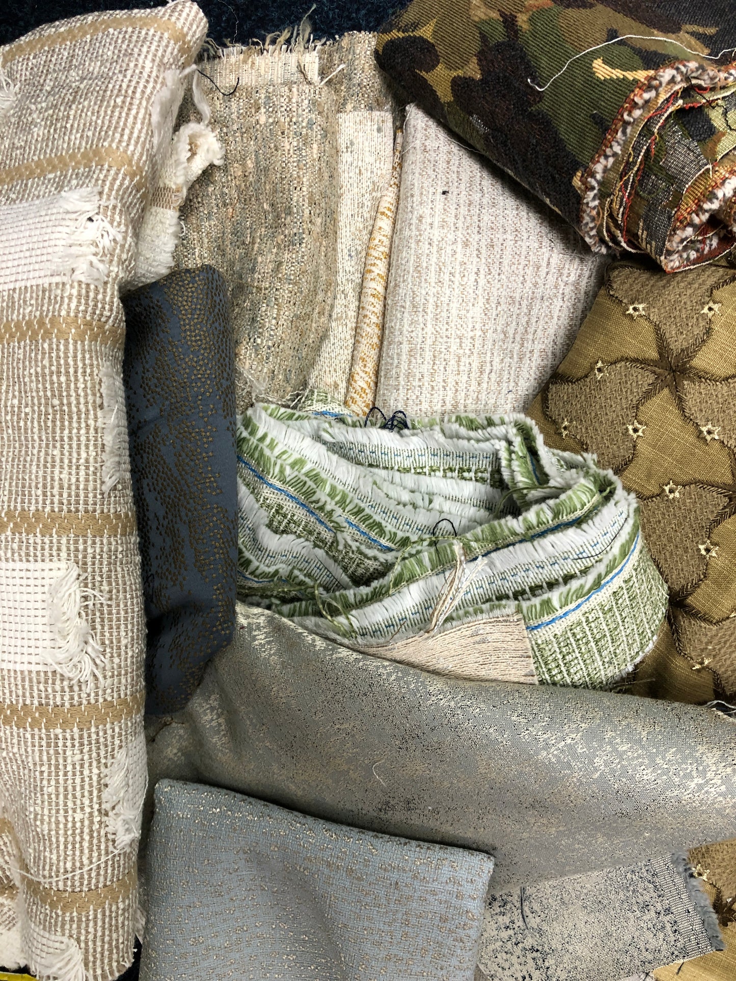 Close-up of various textured fabric samples in a patterned 