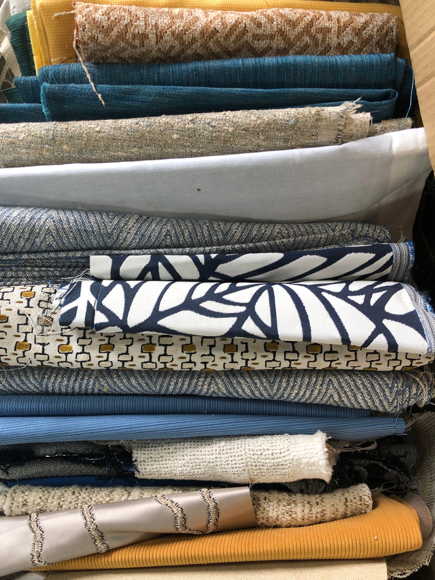 Close-up of various textured fabric samples in a patterned 