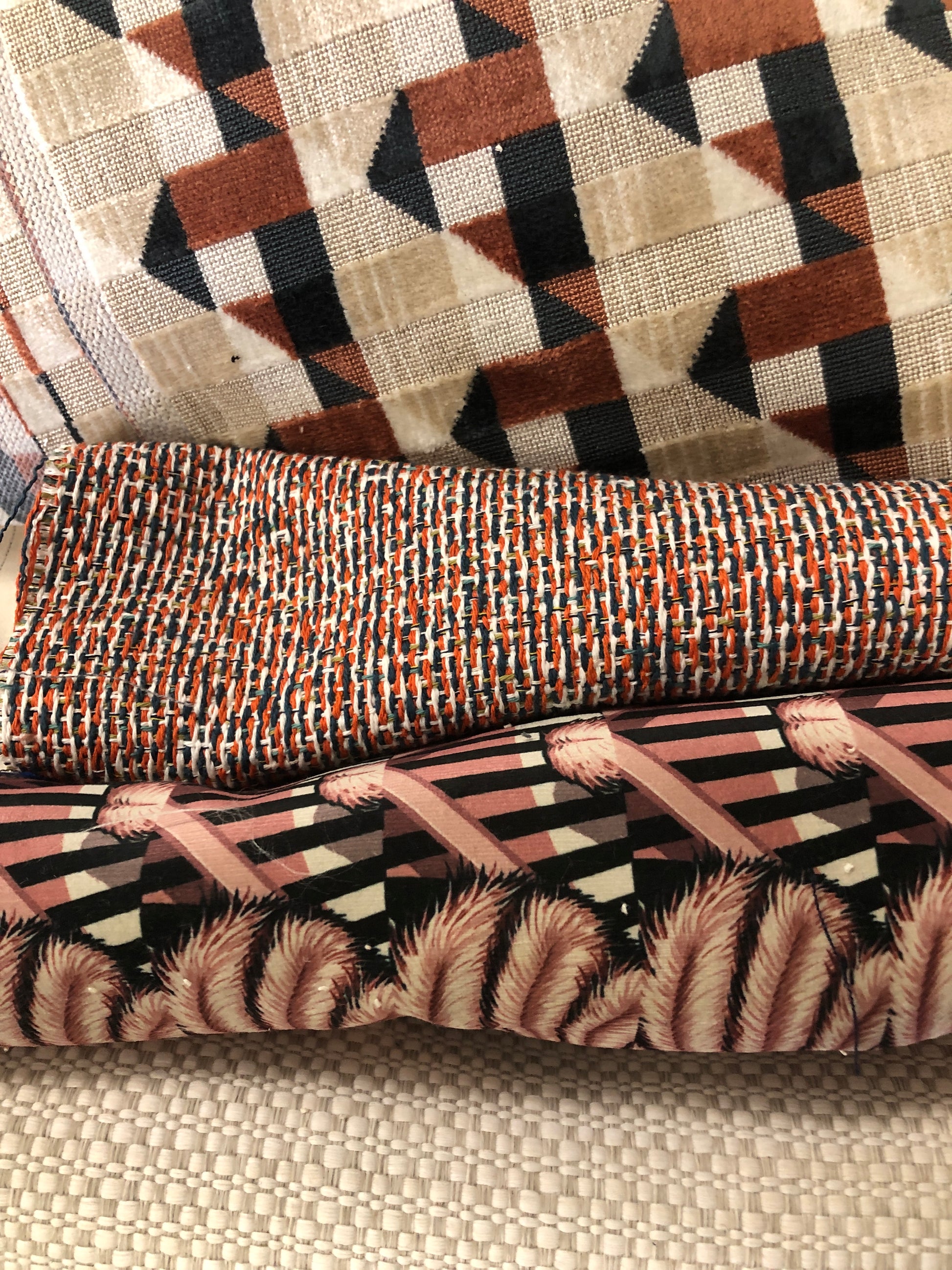 Close-up of various textured fabric samples in a patterned 