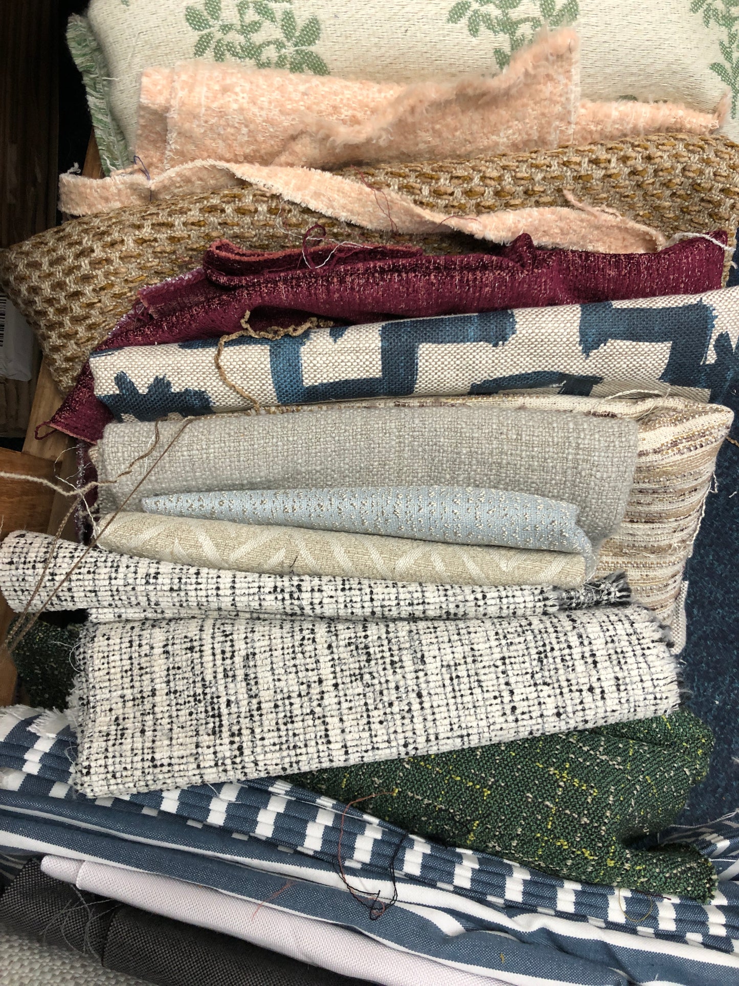 Close-up of various textured fabric samples in a pattern