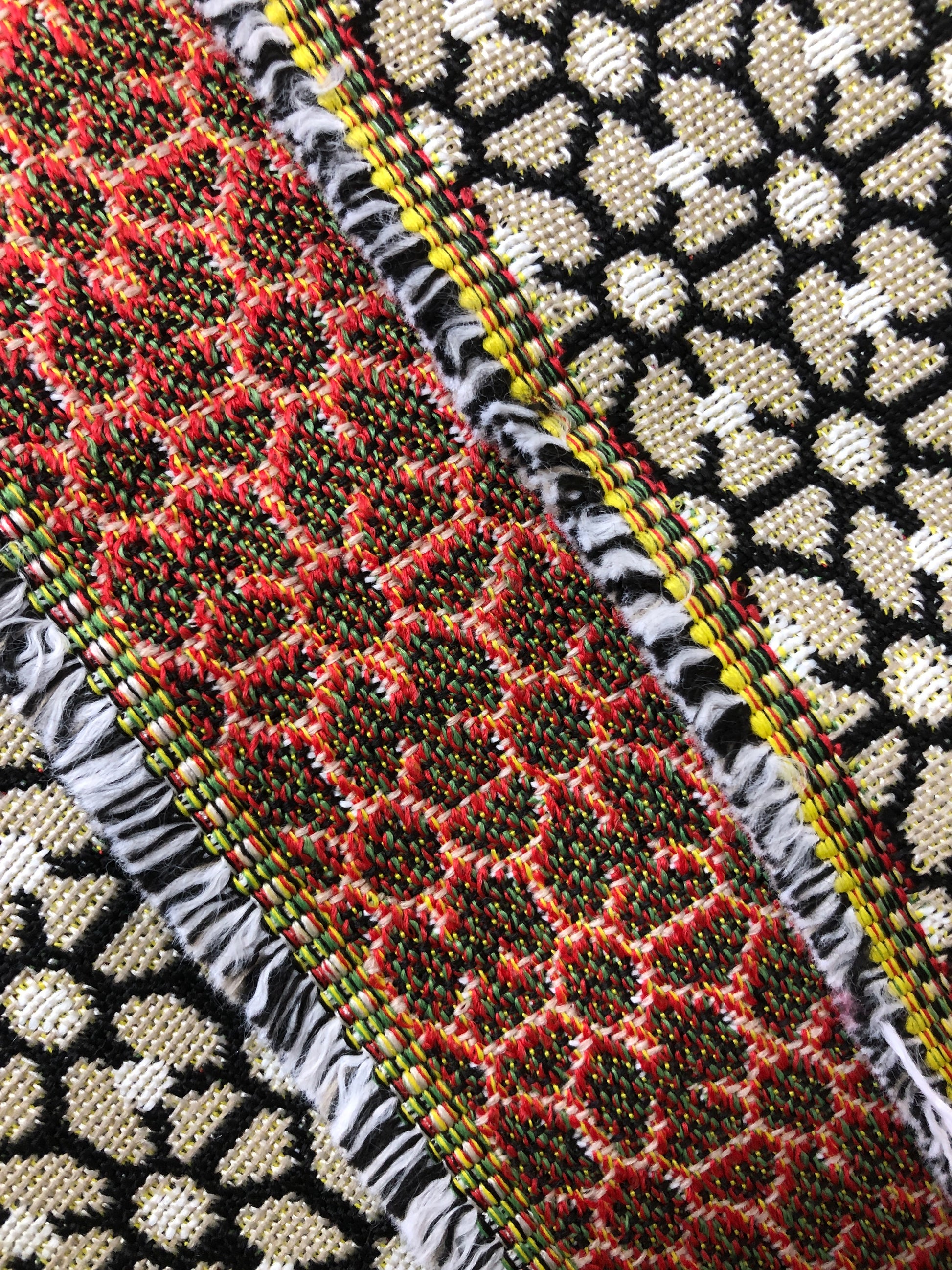 Close-up of various textured fabric samples in a patterned 