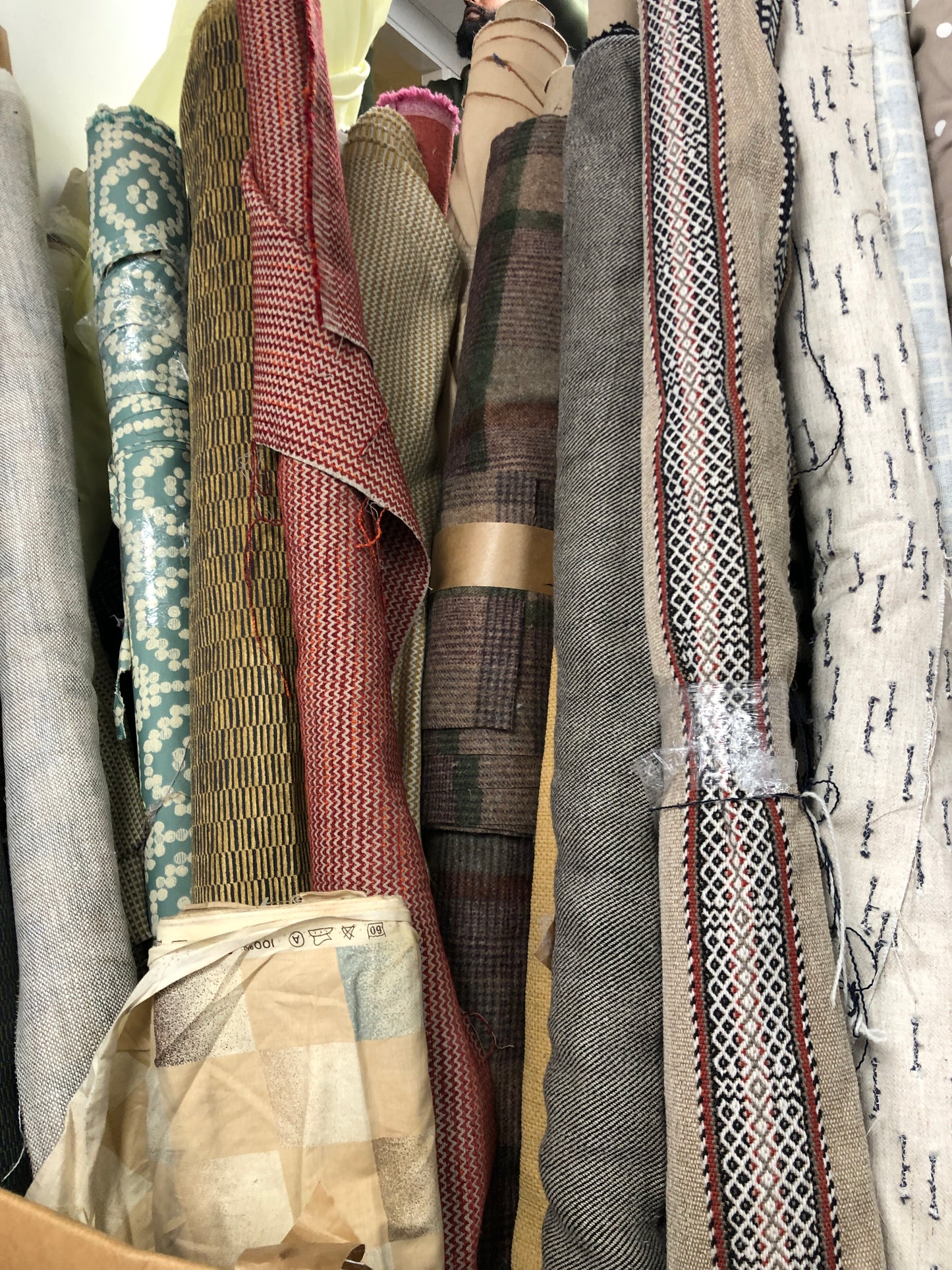 Close-up of various textured fabric samples in a patterned 