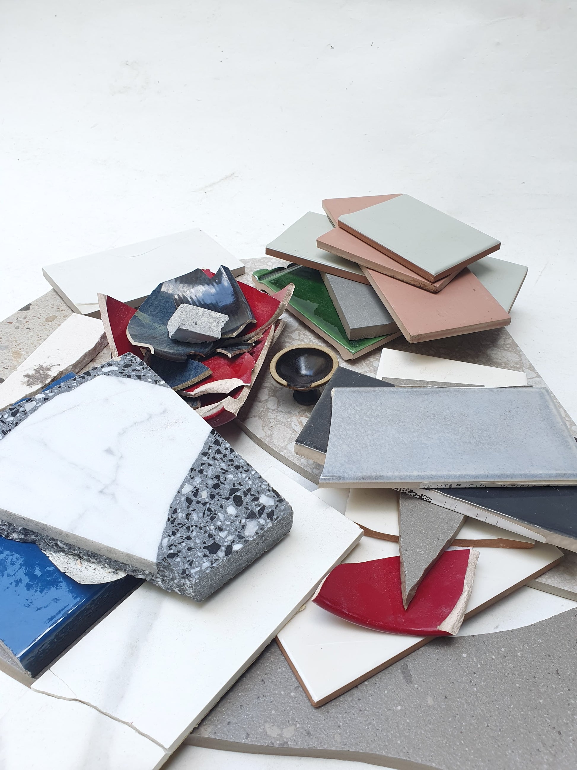 Collection of broken tiles in various colours and sizes 
