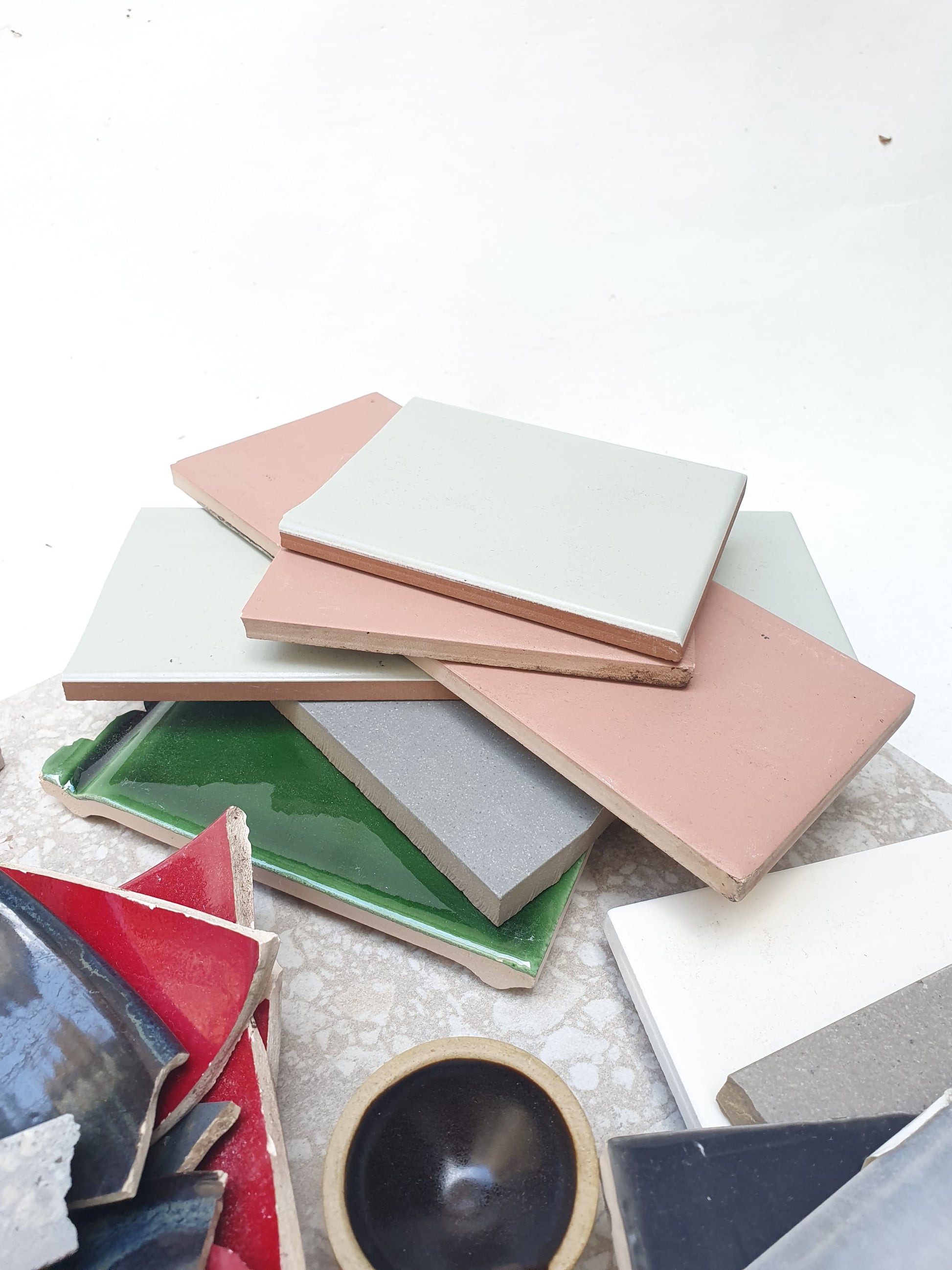 Collection of broken tiles in various colours and sizes 
